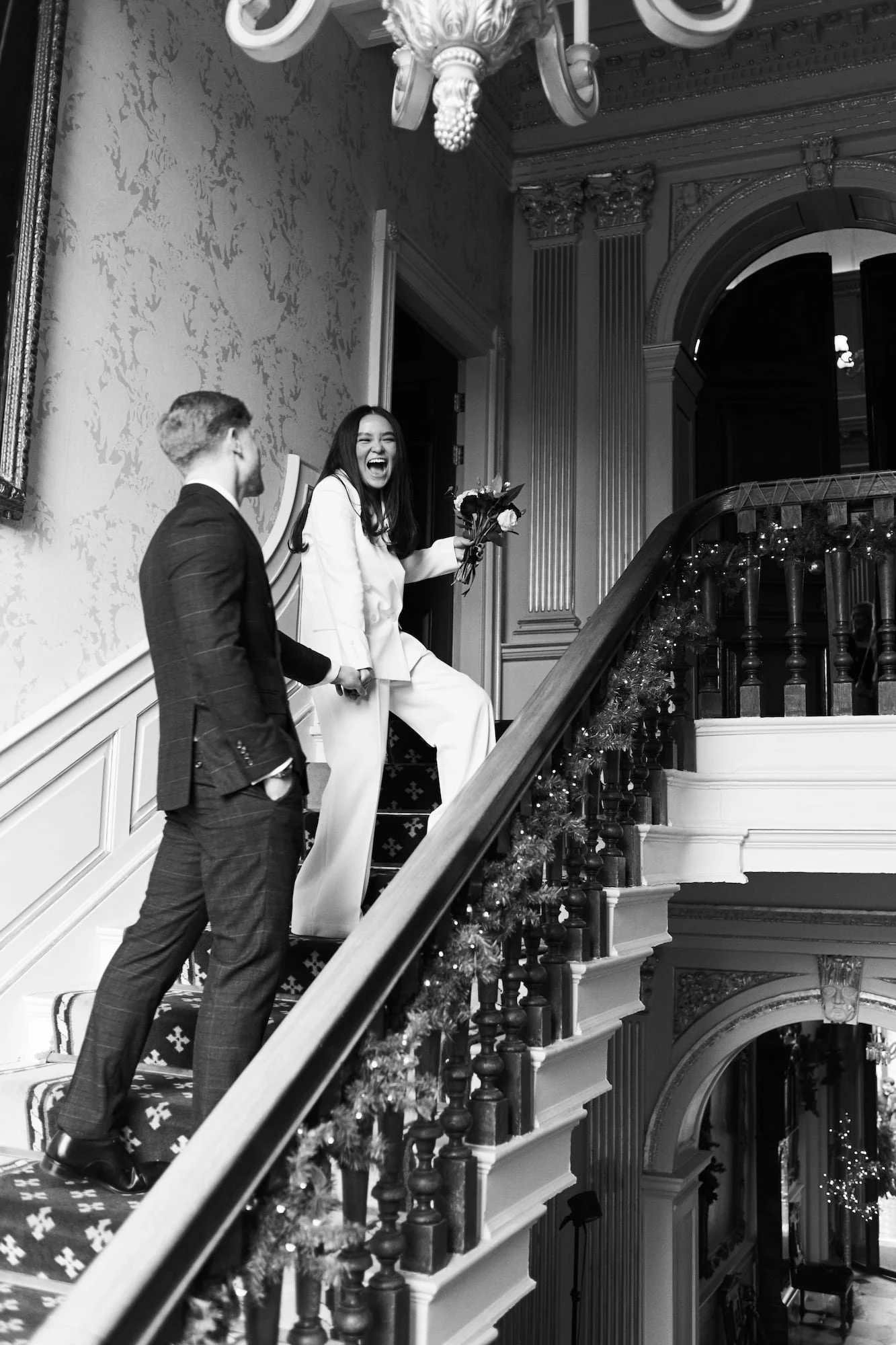 Bride and groom sharing a candid moment inside a historic building