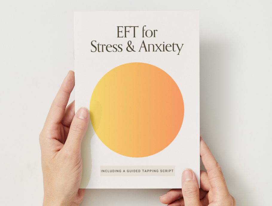 Book titled 'EFT for Stress & Anxiety' with a yellow and orange gradient circle on the cover, being held by hands against a white background.