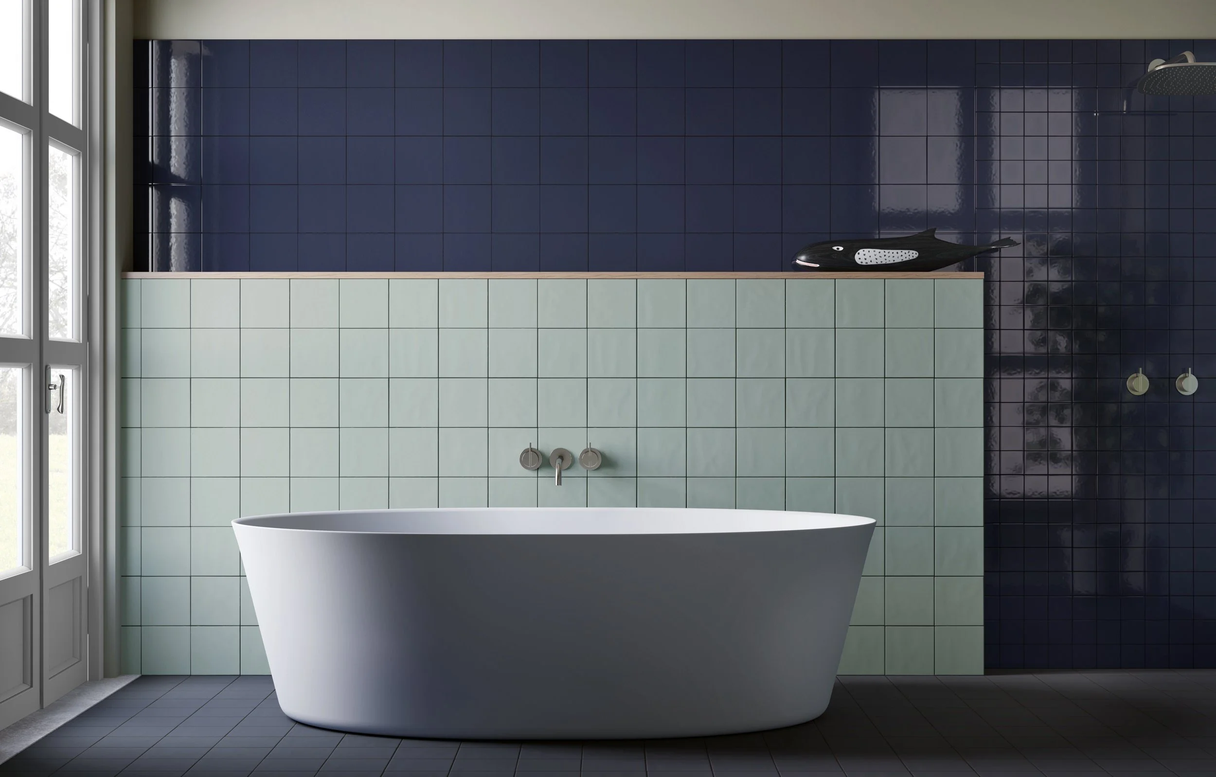Dark blue and green tiles in a bathroom setting showcasing material options at the Hochwert library