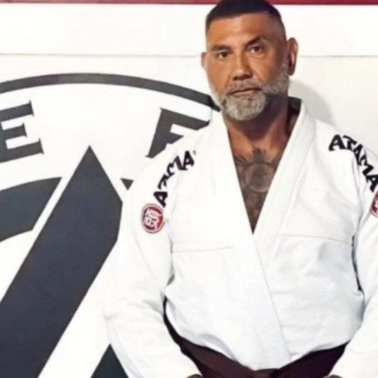 Actor Dave Bautista in a white martial arts gi.