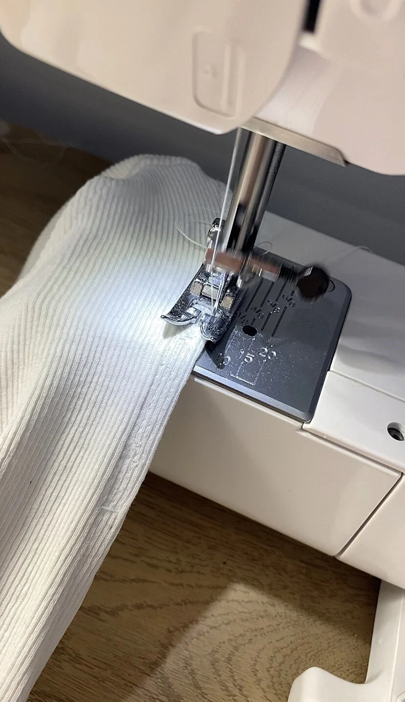 repairing someone's clothes using the sewing machine