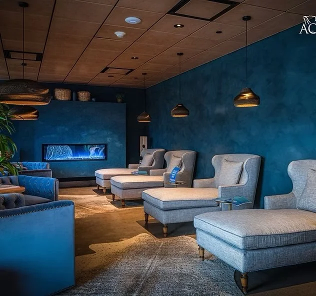 A blue spa room with large chaise lounges - Aqua Spa Float Center