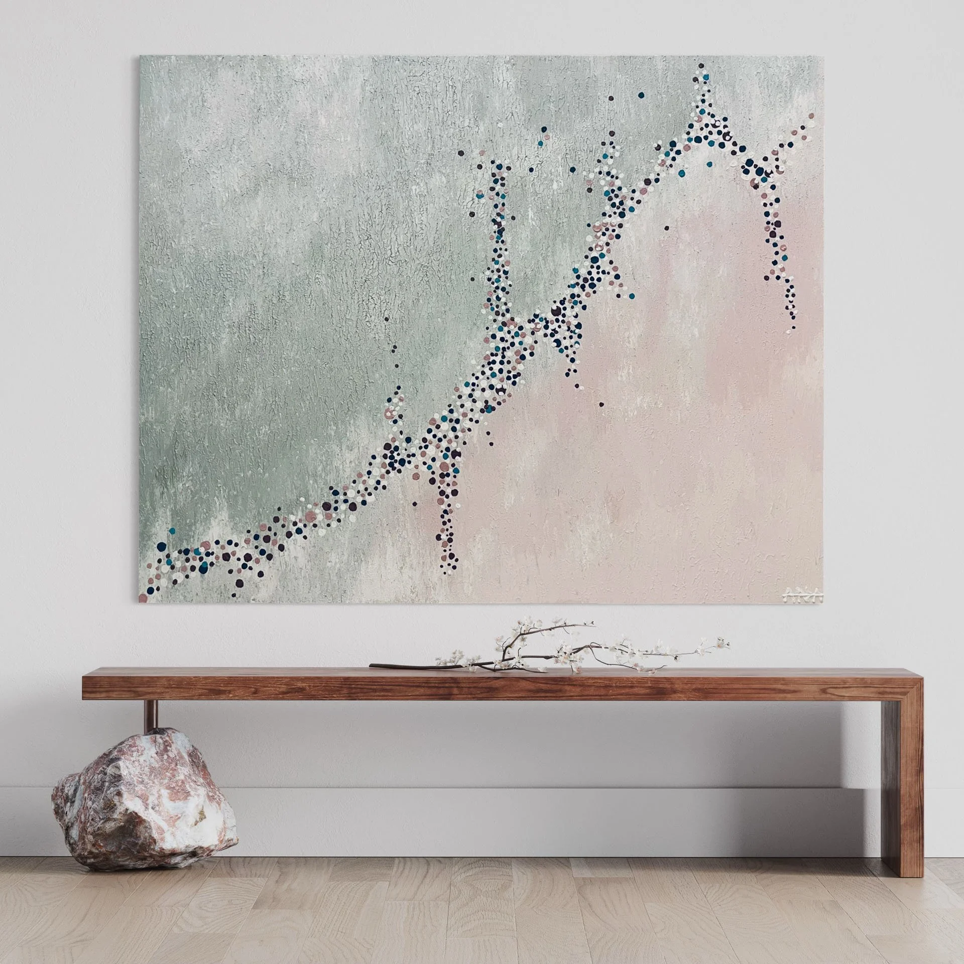Minimalist art gallery featuring a large abstract painting with a dotted line pattern on a textured light gray background, a wooden shelf, and a large rock on the floor.
