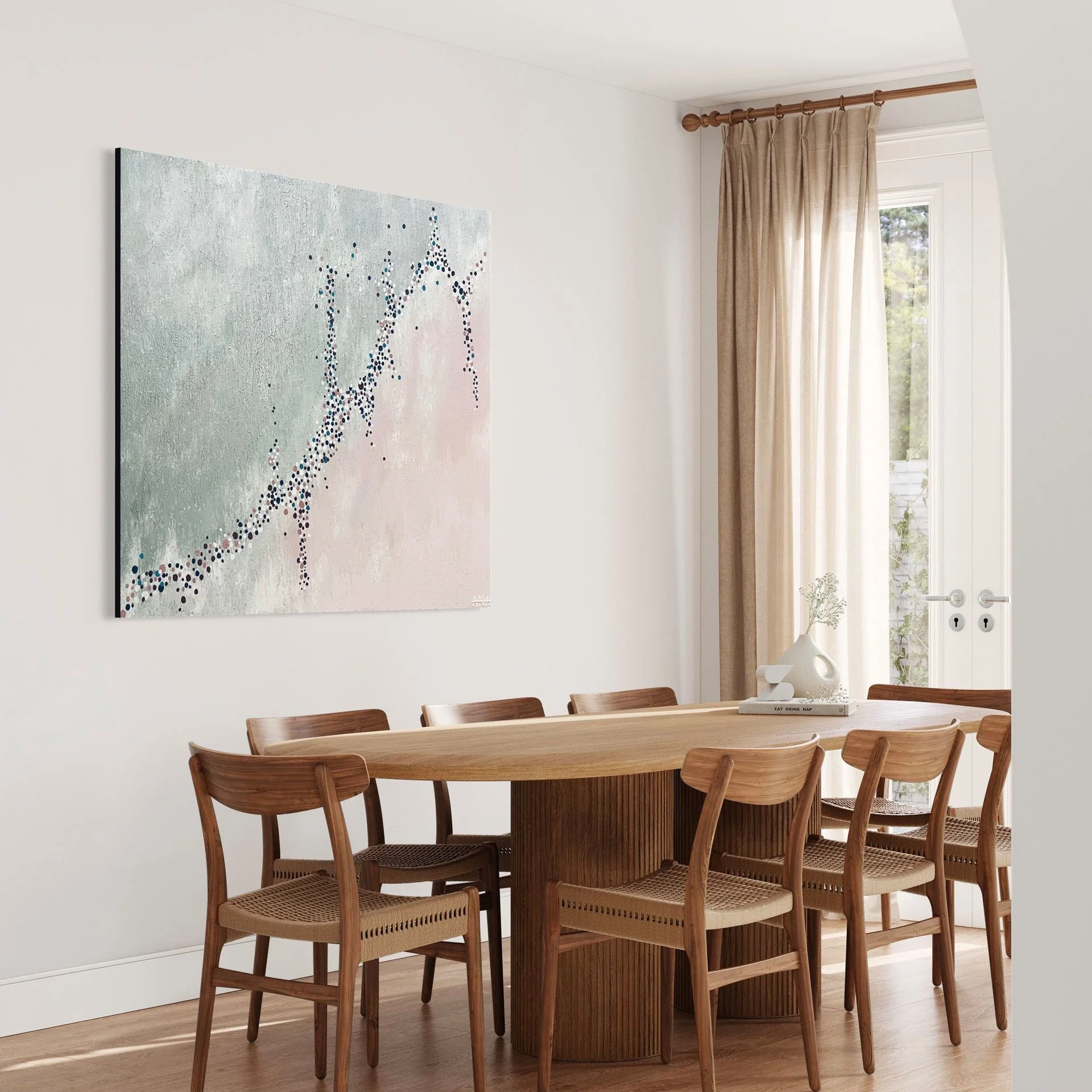 A dining room with a wooden table and ten matching wooden chairs. The room has light-colored walls, a window with beige curtains, and a piece of abstract art on the wall. There is a white decorative object on the table and wooden flooring.