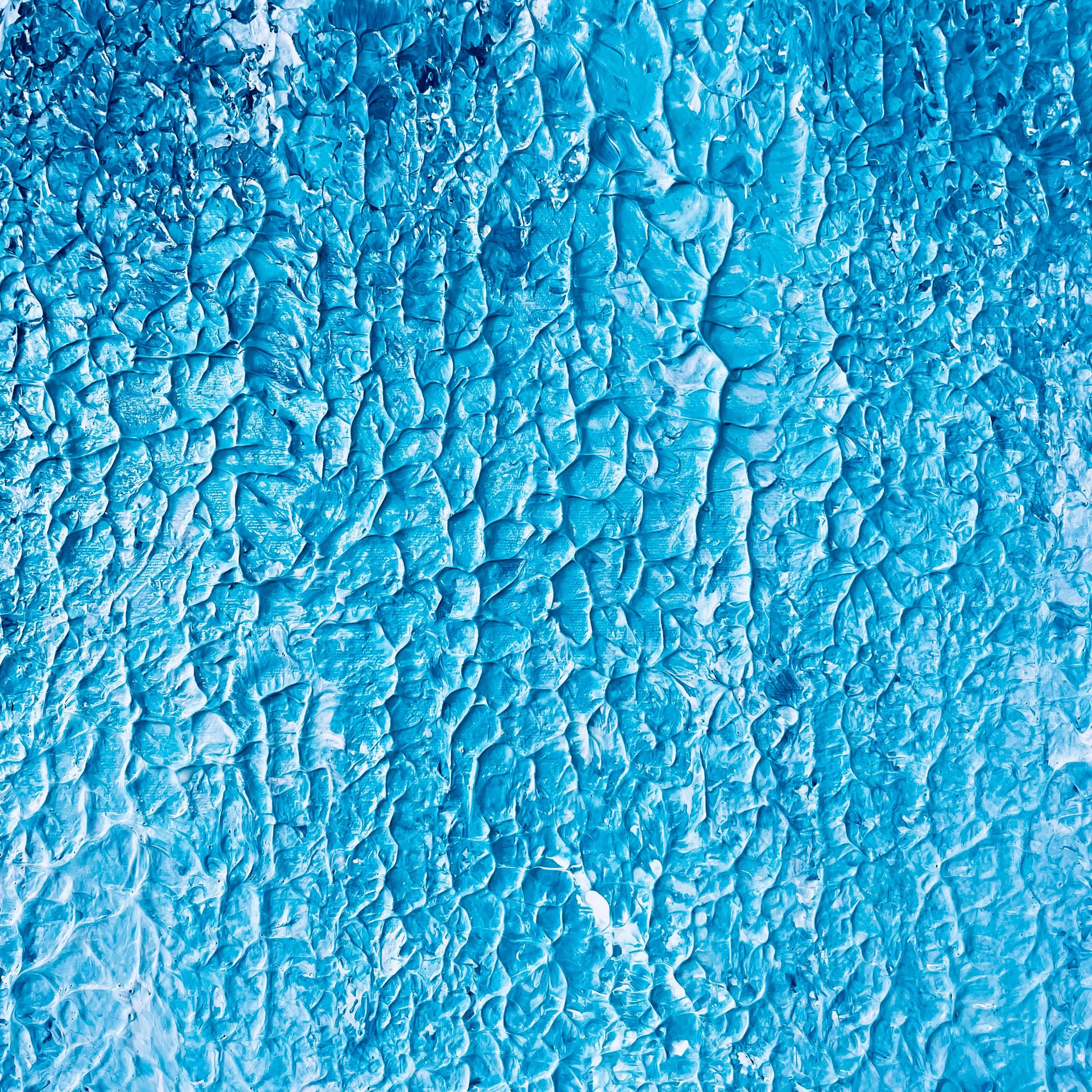 Close-up of a textured, crinkled surface of blue plastic material