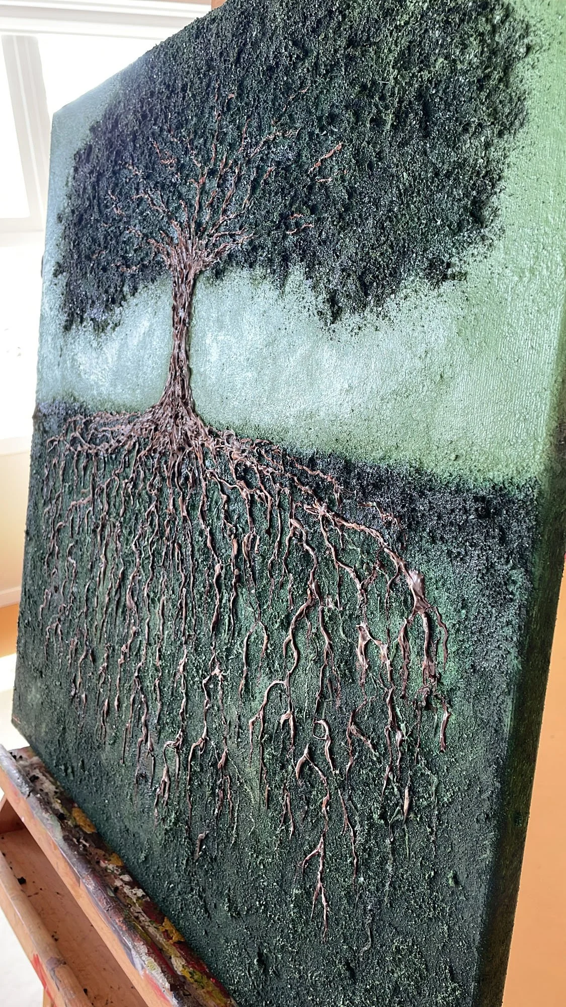 A textured painting of a tree with roots and branches extending across a rectangular canvas.