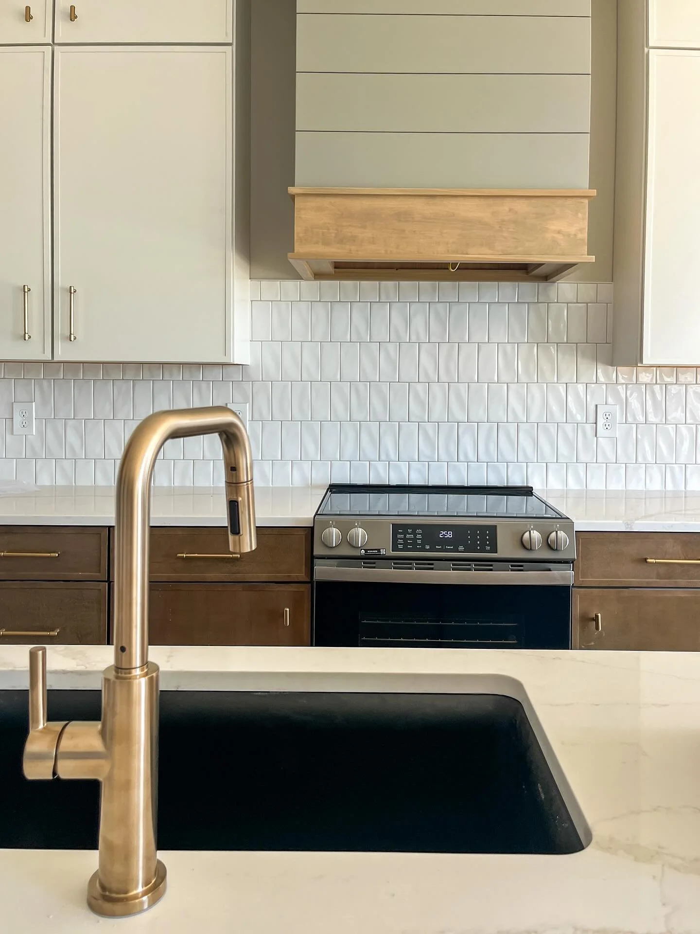 Even in new construction, we aim for thoughtfully lived-in, even if everything is brand new.

Layering textures like wood, stone, and soft matte finishes brings warmth and depth to a modern kitchen, making it feel welcoming from day one.

This one&rs
