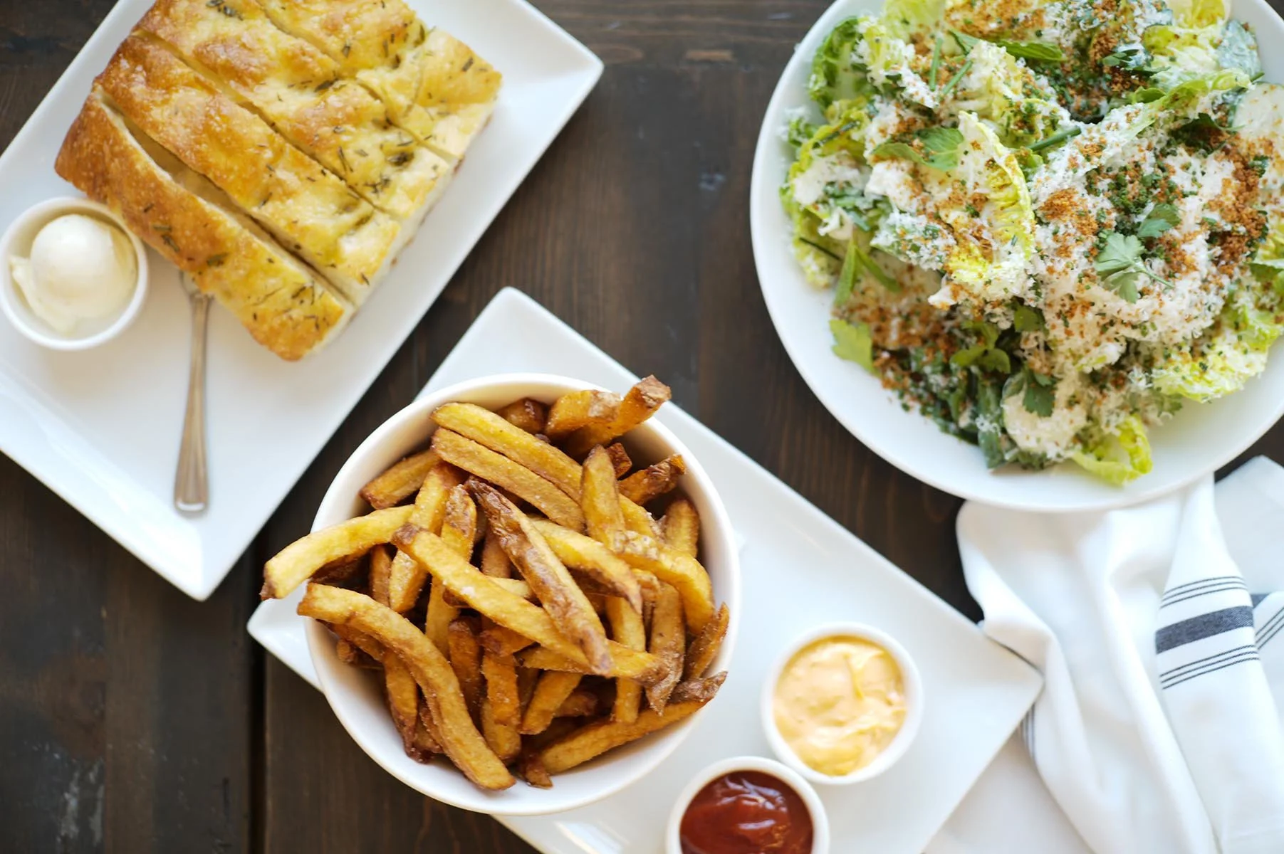 House-made focaccia with seasonal compound butter, french fries, and gem salad with buttermilk vinaigrette.