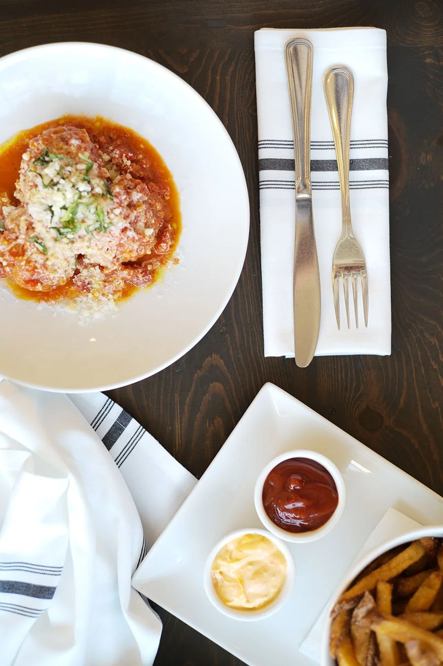 Chicken and ricotta meatballs with parmigiano reggiano and french fries with aioli.