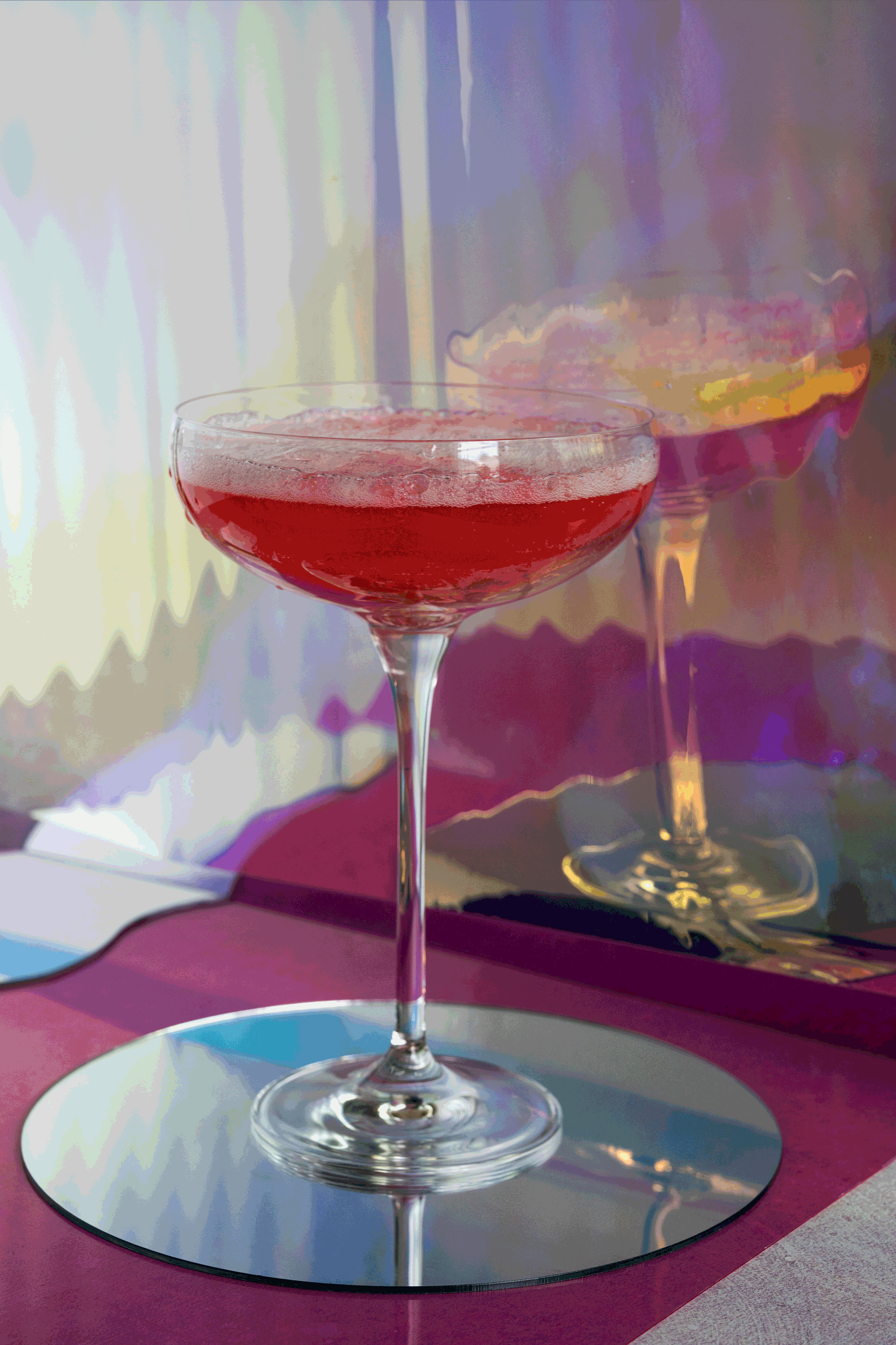 A gif of a cotton candy cocktail disintegrating.