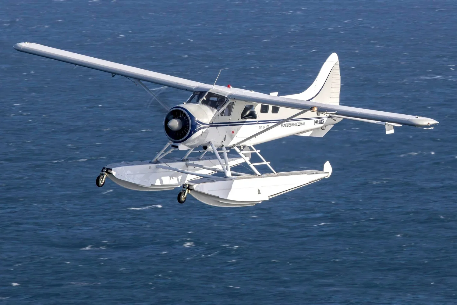 Sydney By Seaplane aircraft flying over the water on the way to Palm Beach