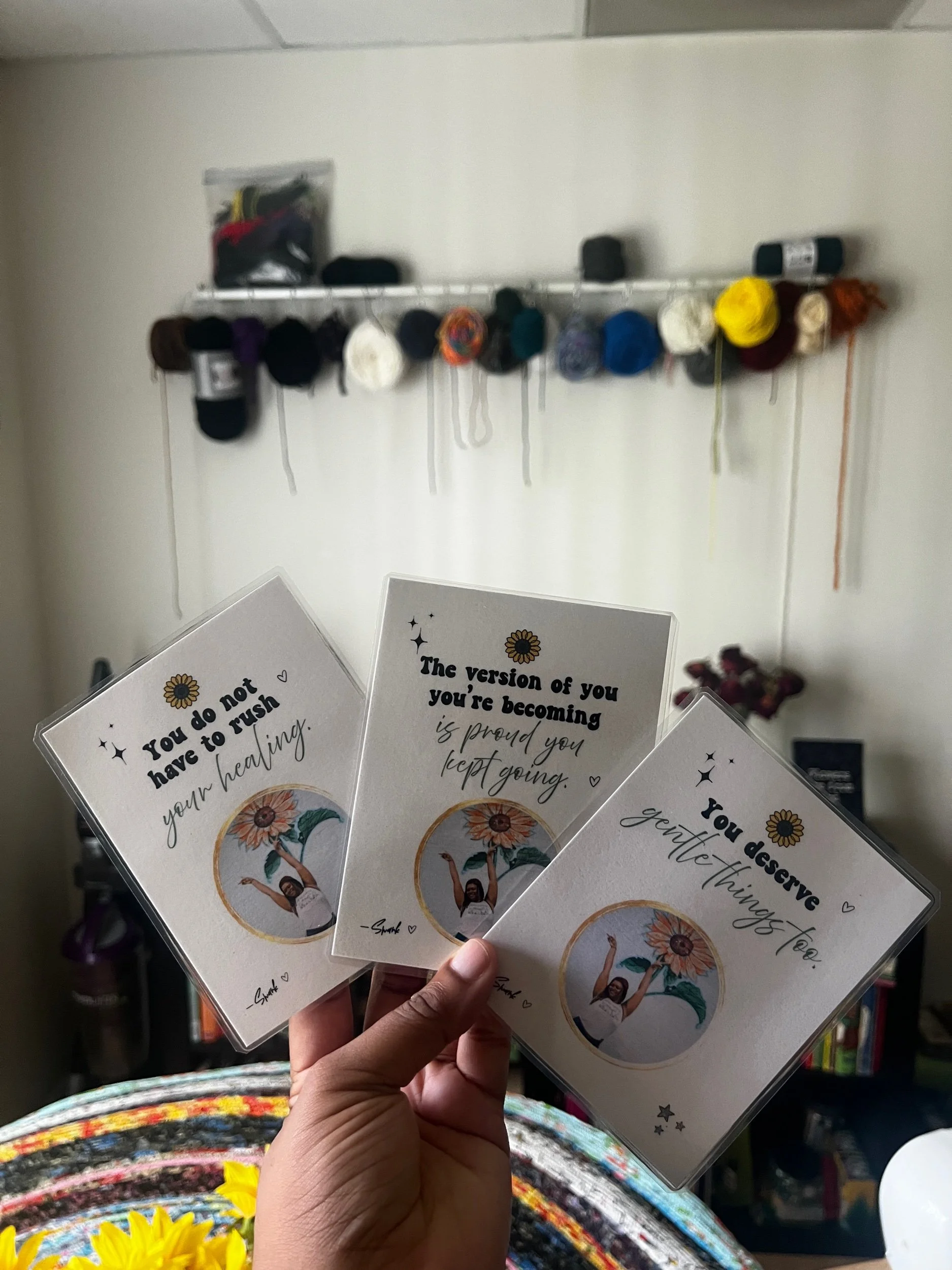 Hand holding three motivational affirmation cards featuring encouragement and healing messages (Copy) (Copy)