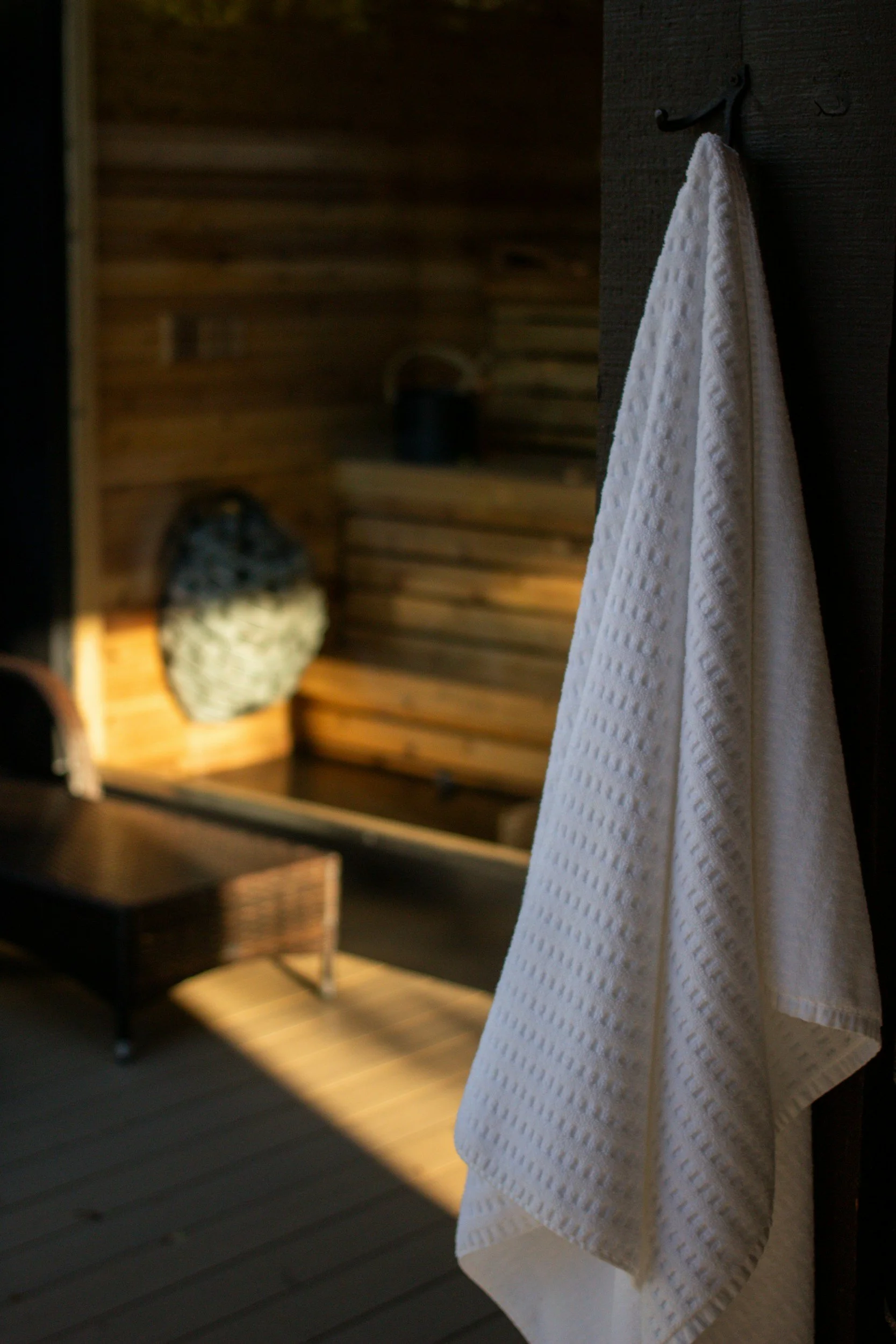Towel hanging with sauna in background