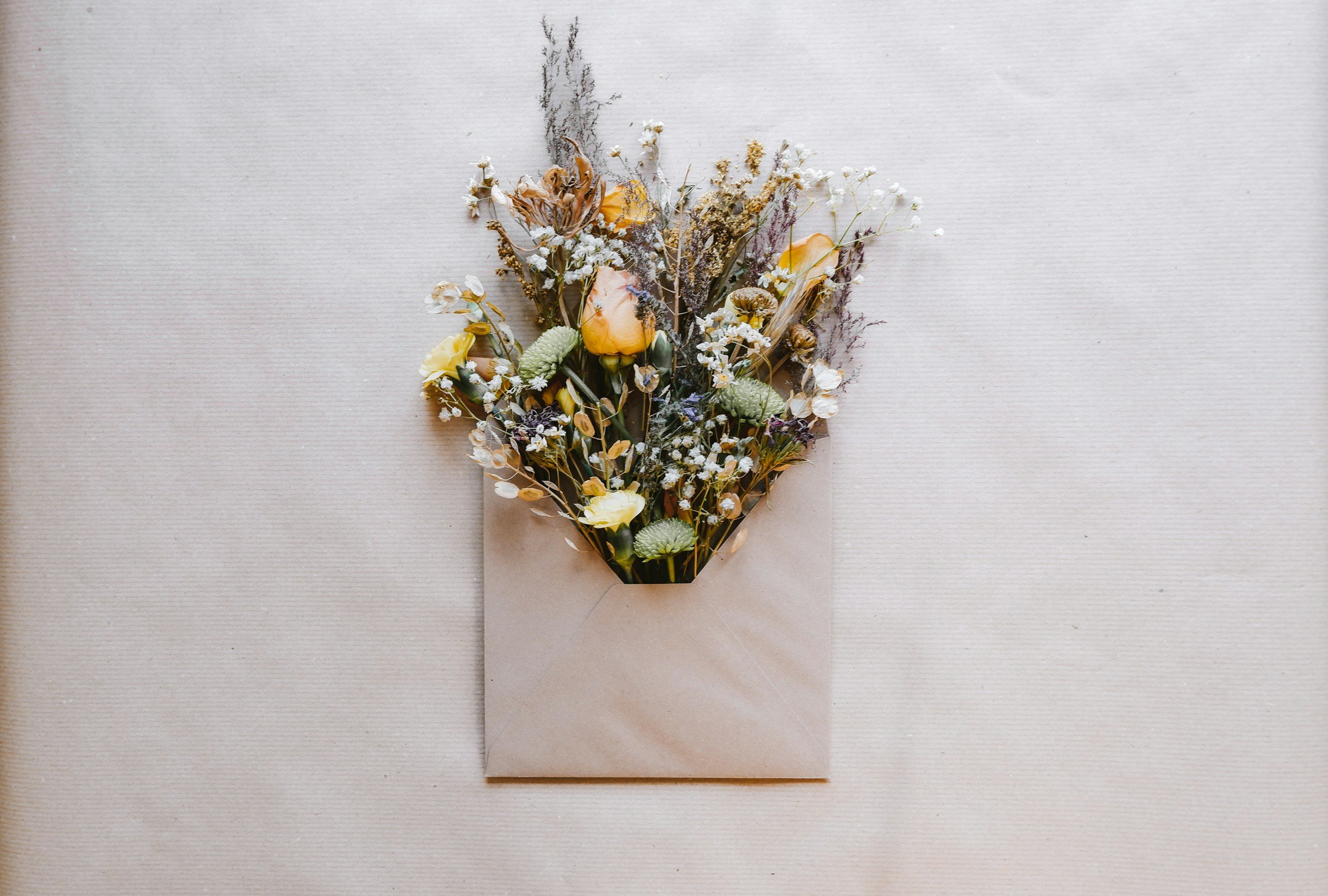 Envelope with dried flowers bursting out