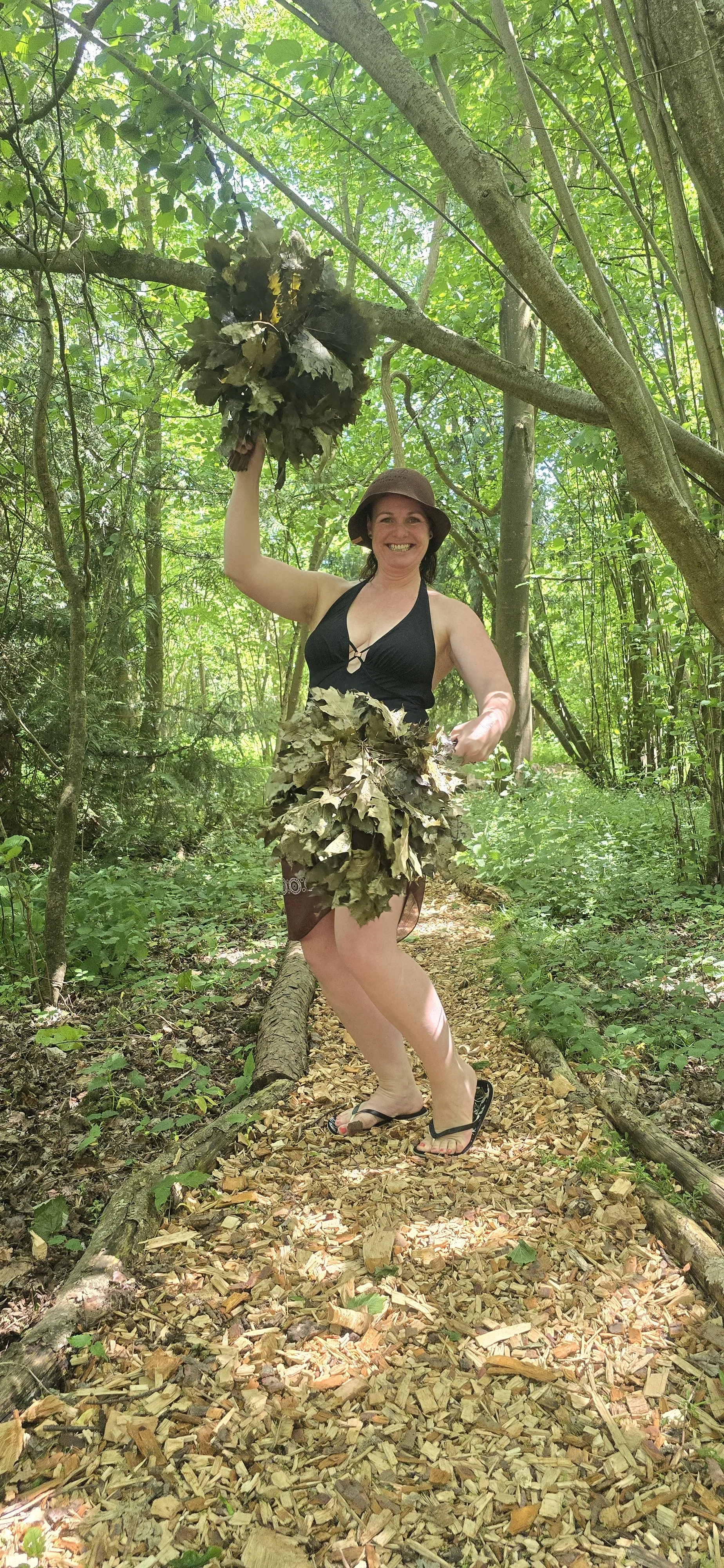 Sauna Master Chantelle with her oak whisks laughing