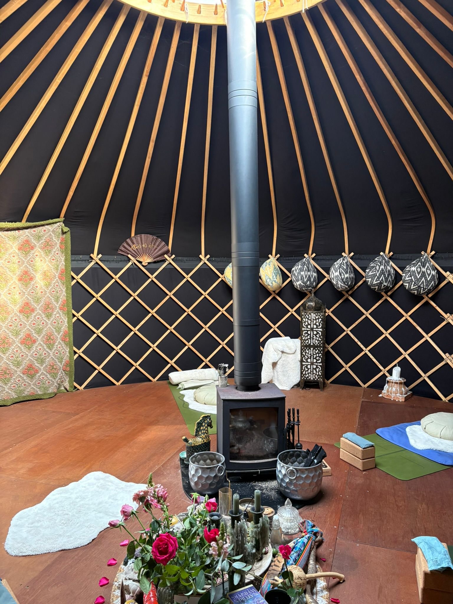 Inside a yoga teepee with fire in the middle and offerings