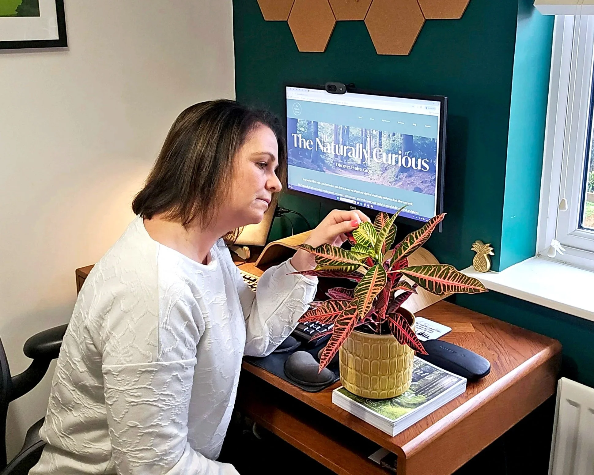 Chantelle looking at patterns on a leaf from a house plant