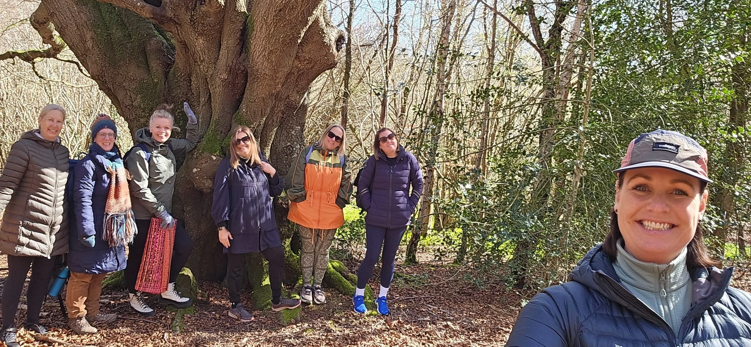 Guide and Group in the woods smiling