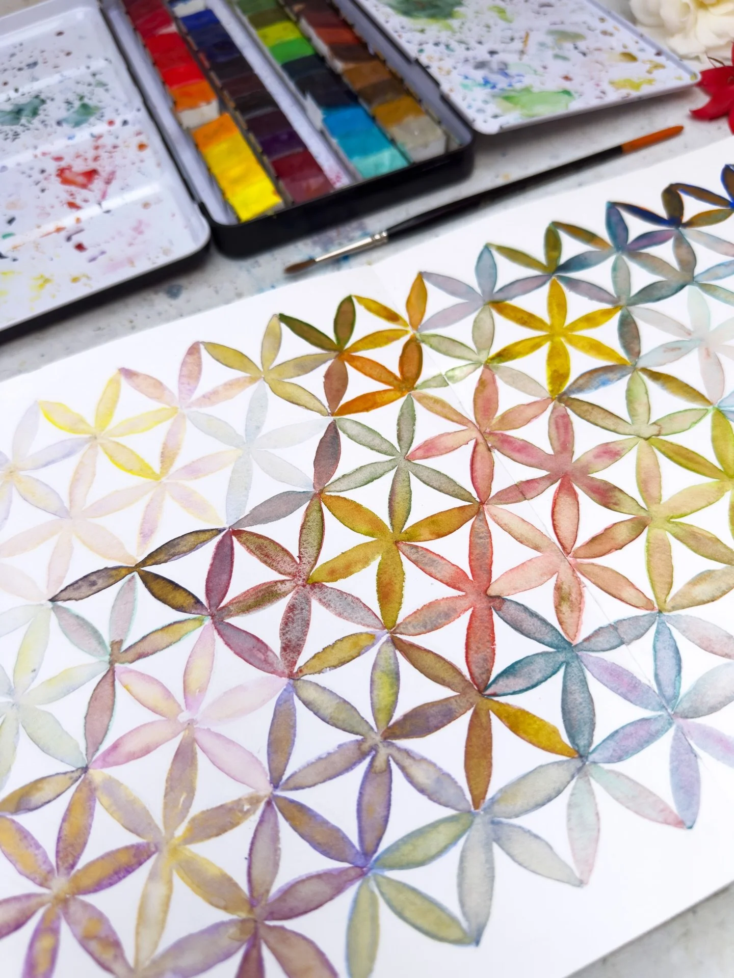 There is a watercolour meditation journal spread that only exists because of a sprained ankle.
This spread was made with the sketchbook fighting for space on my lap &mdash; the kitters asserting their prior claim, the palette balanced on the armrest,