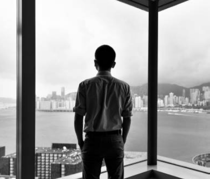 A man staring out of an office window