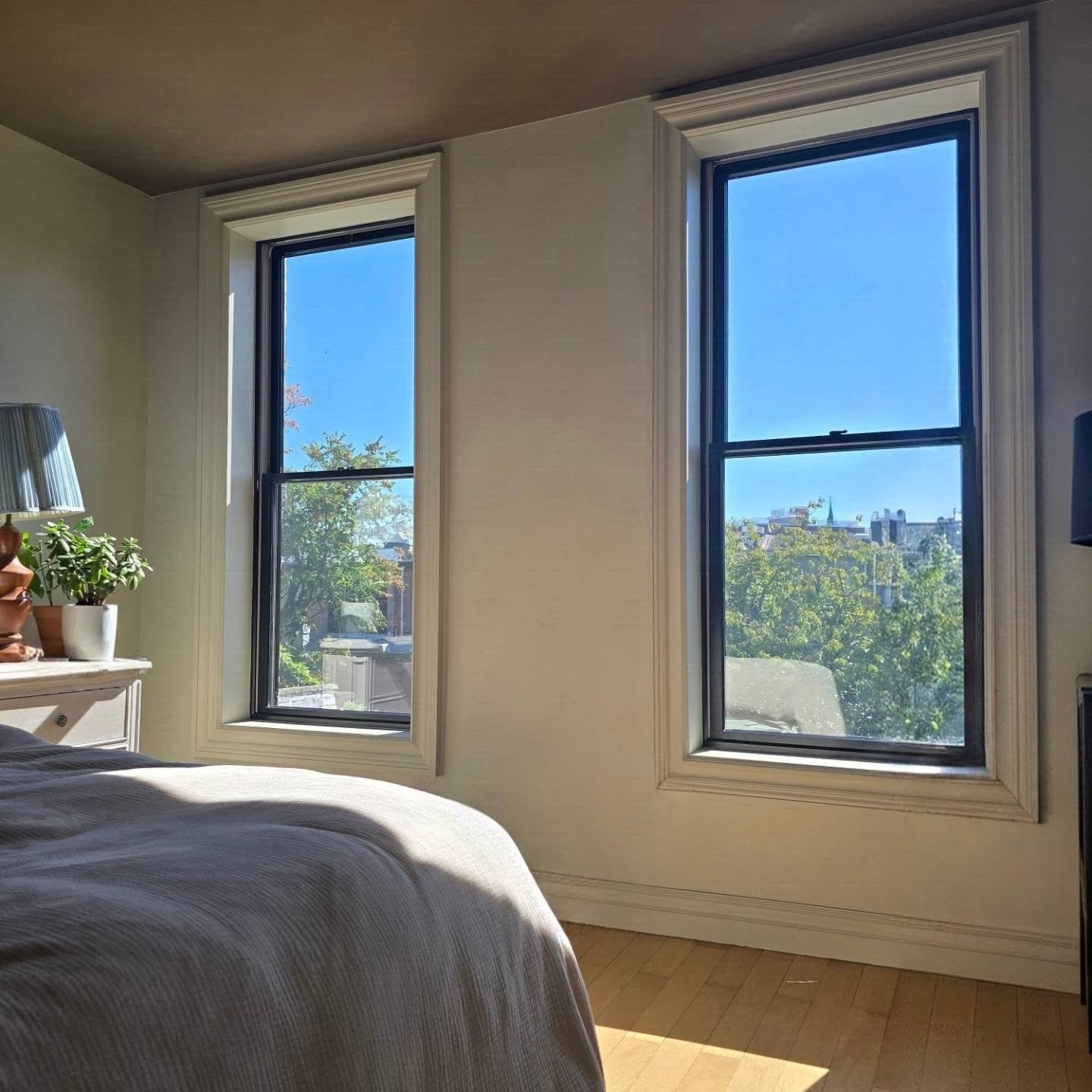 This historic Bed Stuy home needed both energy performance upgrades and architectural TLC. We replaced the original windows with high-efficiency modern Andersen black-framed units, and custom restored each frame to maintain those rich interior moldin