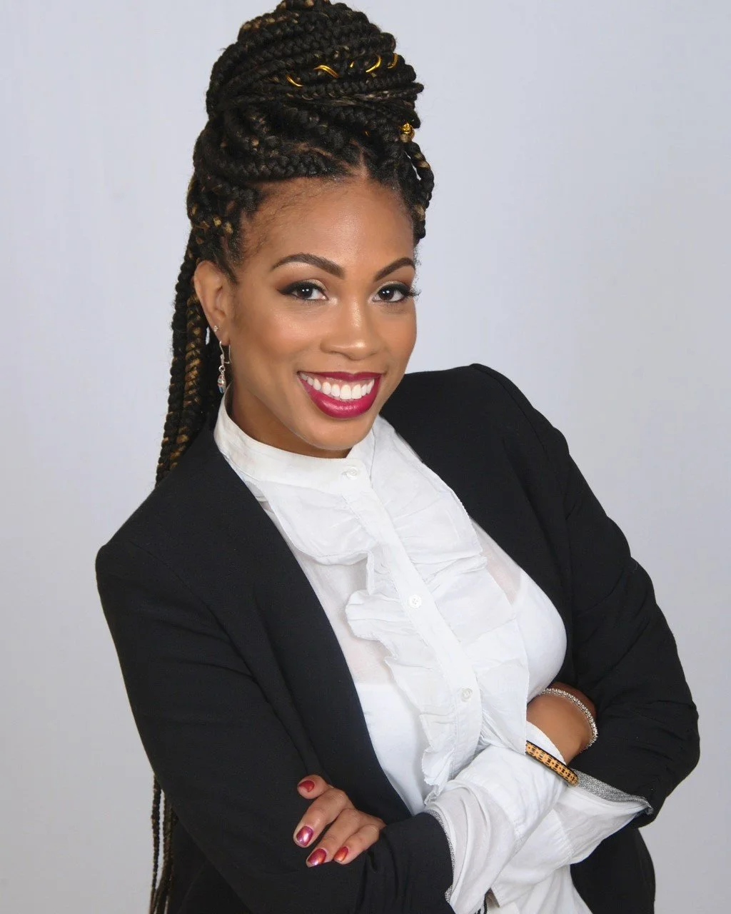Smiling woman with braided hair in a business suit