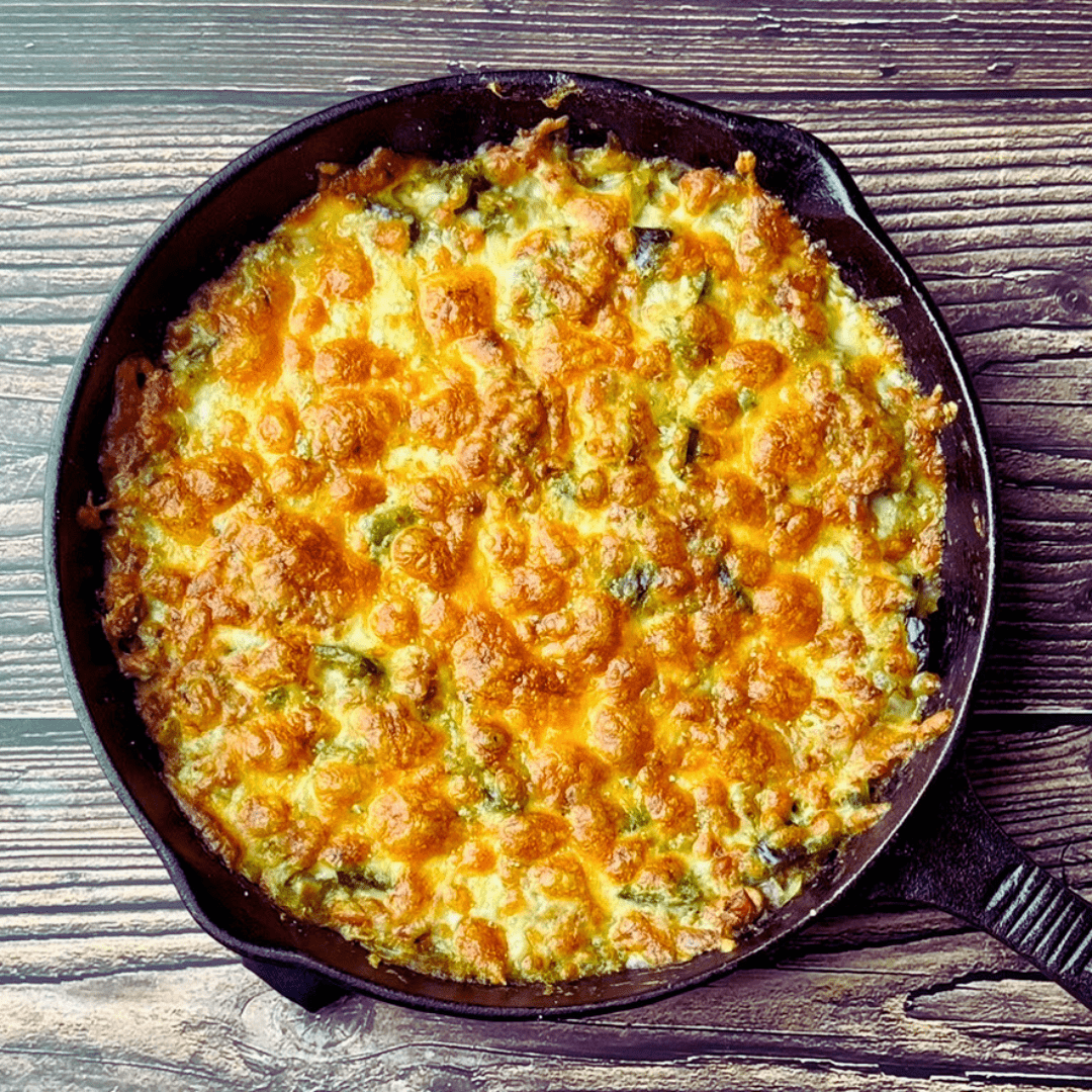 Photo of a skillet of cheesy bean enchilada bake