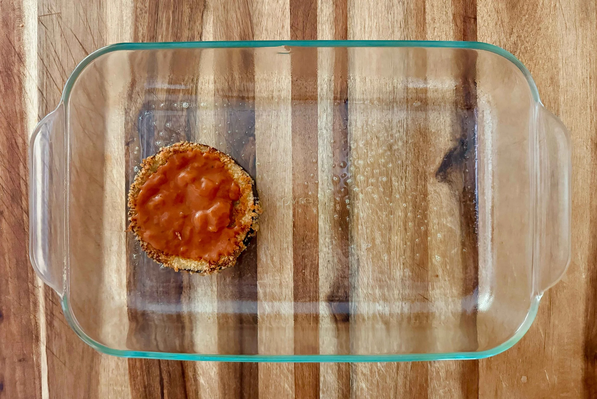 Photo of marinara on top of eggplant slice