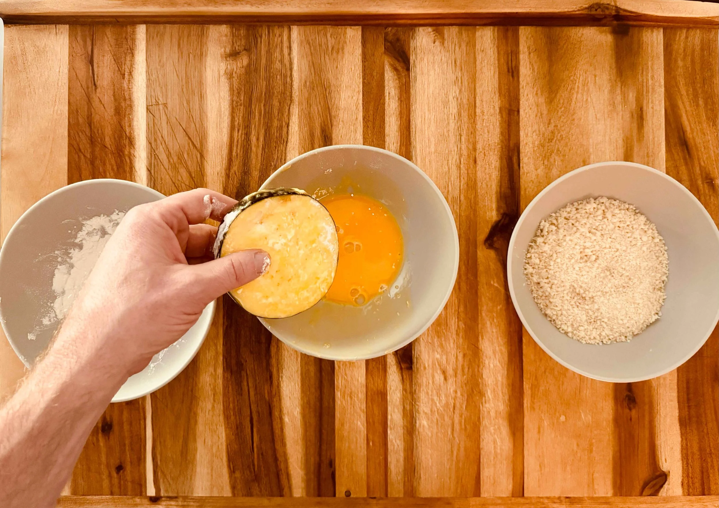 phot of an eggplant slice dipped in egg