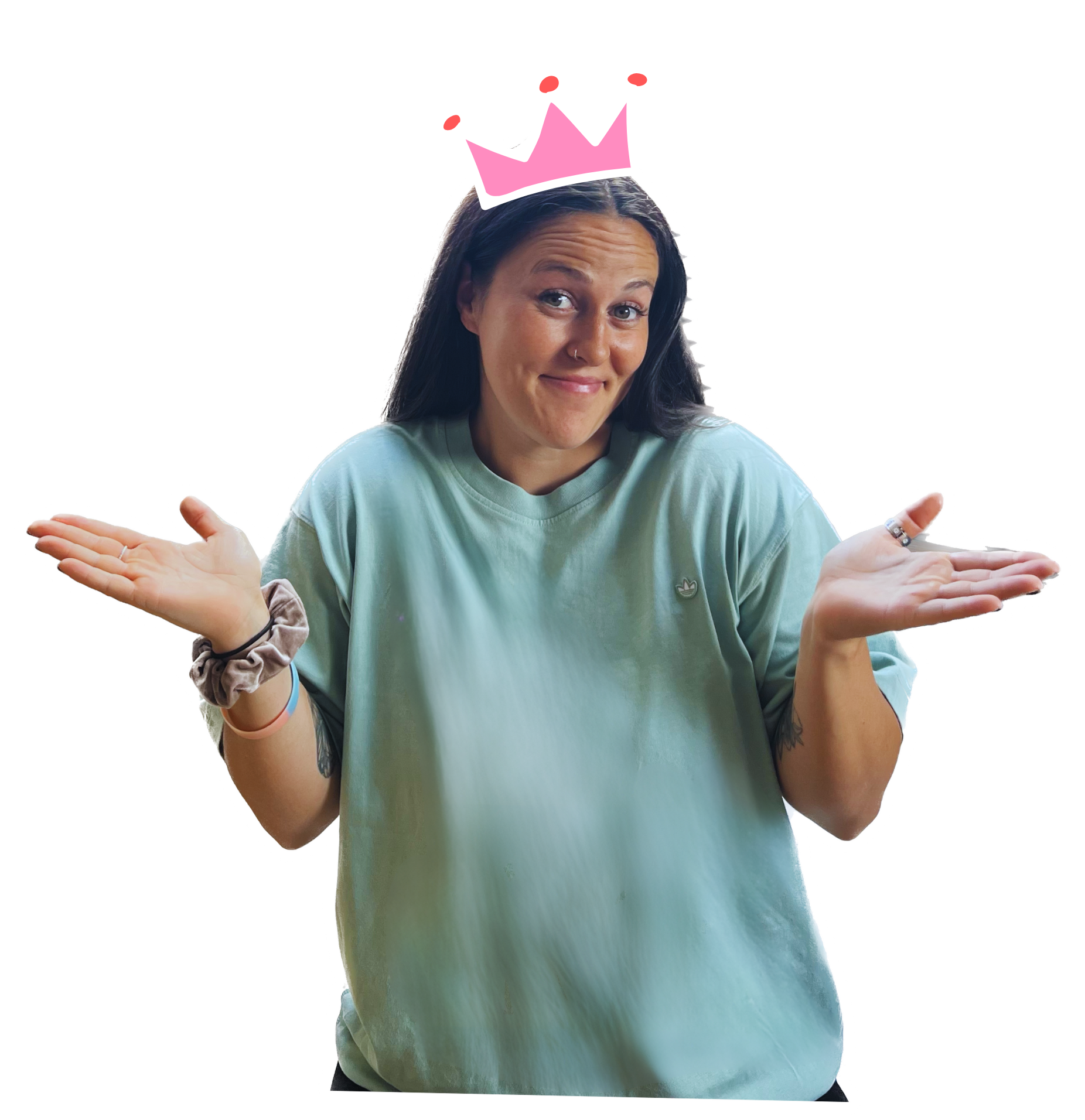 A woman with dark hair, wearing a light blue t-shirt, is shrugging her shoulders with a playful expression. She has a pink crown illustration above her head, indicated as a sticker.