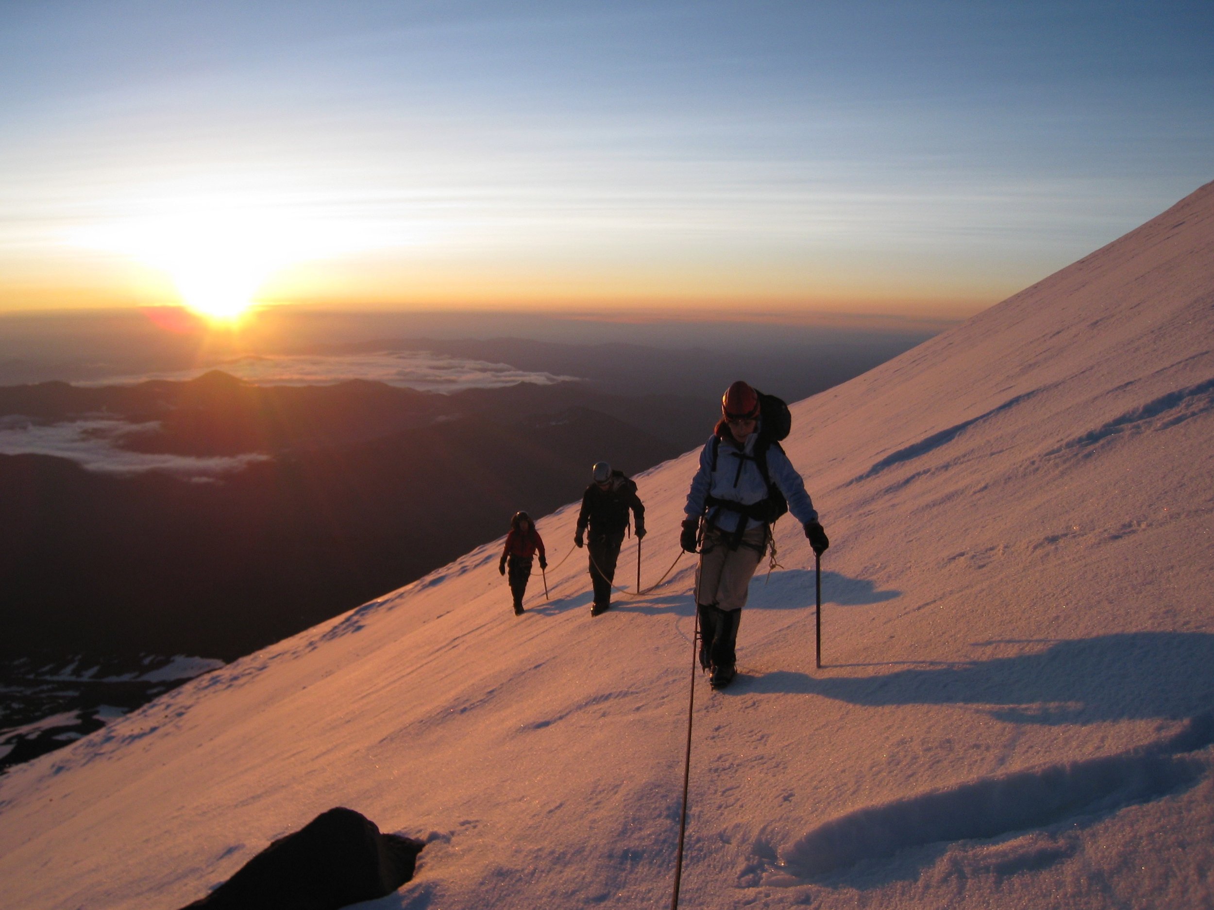 mountaineers climb in the sun rise on mt shasta. 