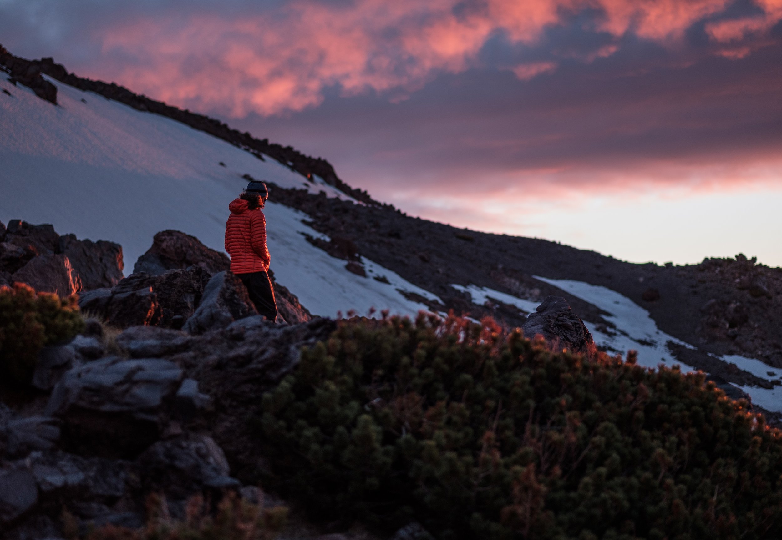 Climber walks around camp during sunset