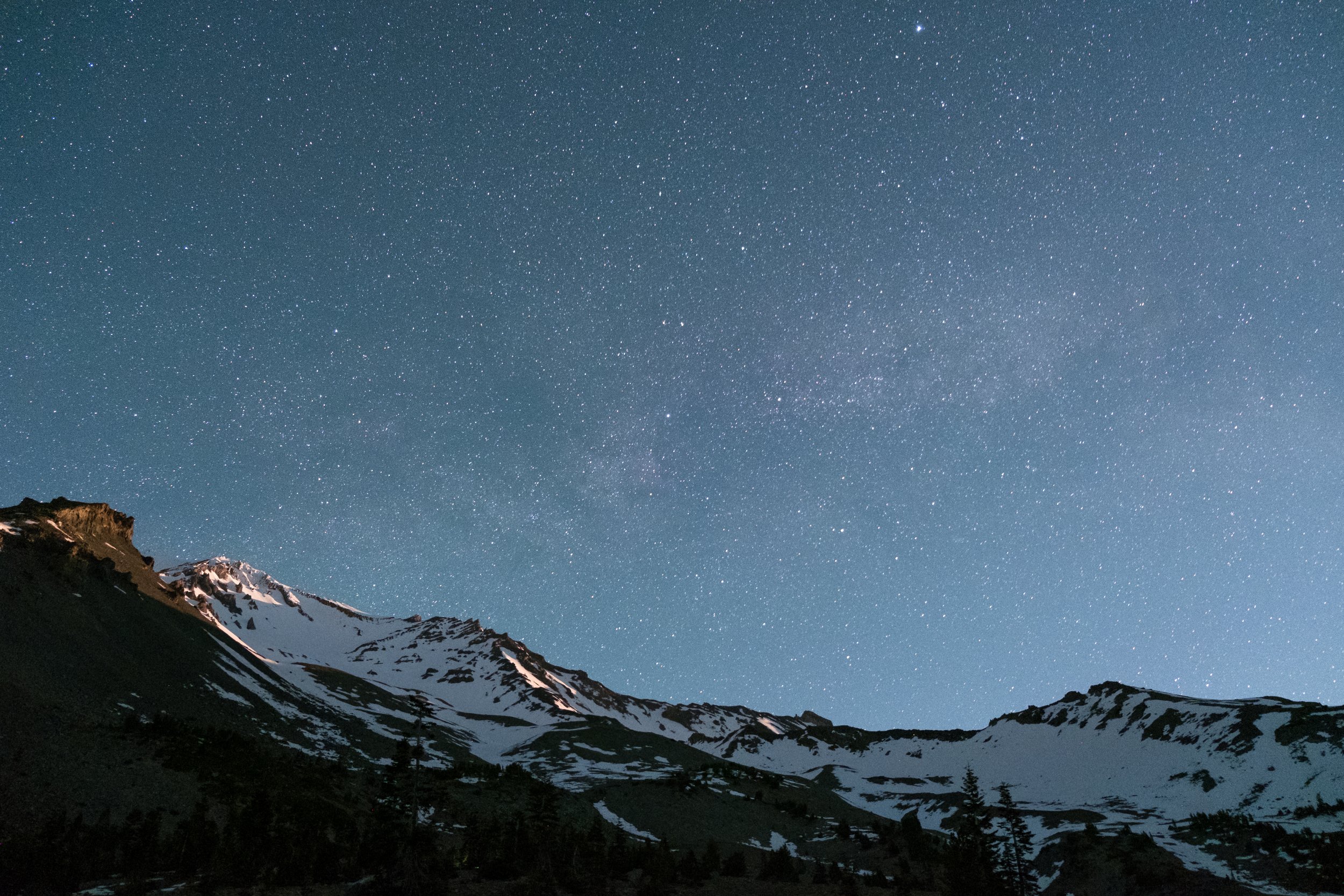 Mount Shasta in the dark with stars all around