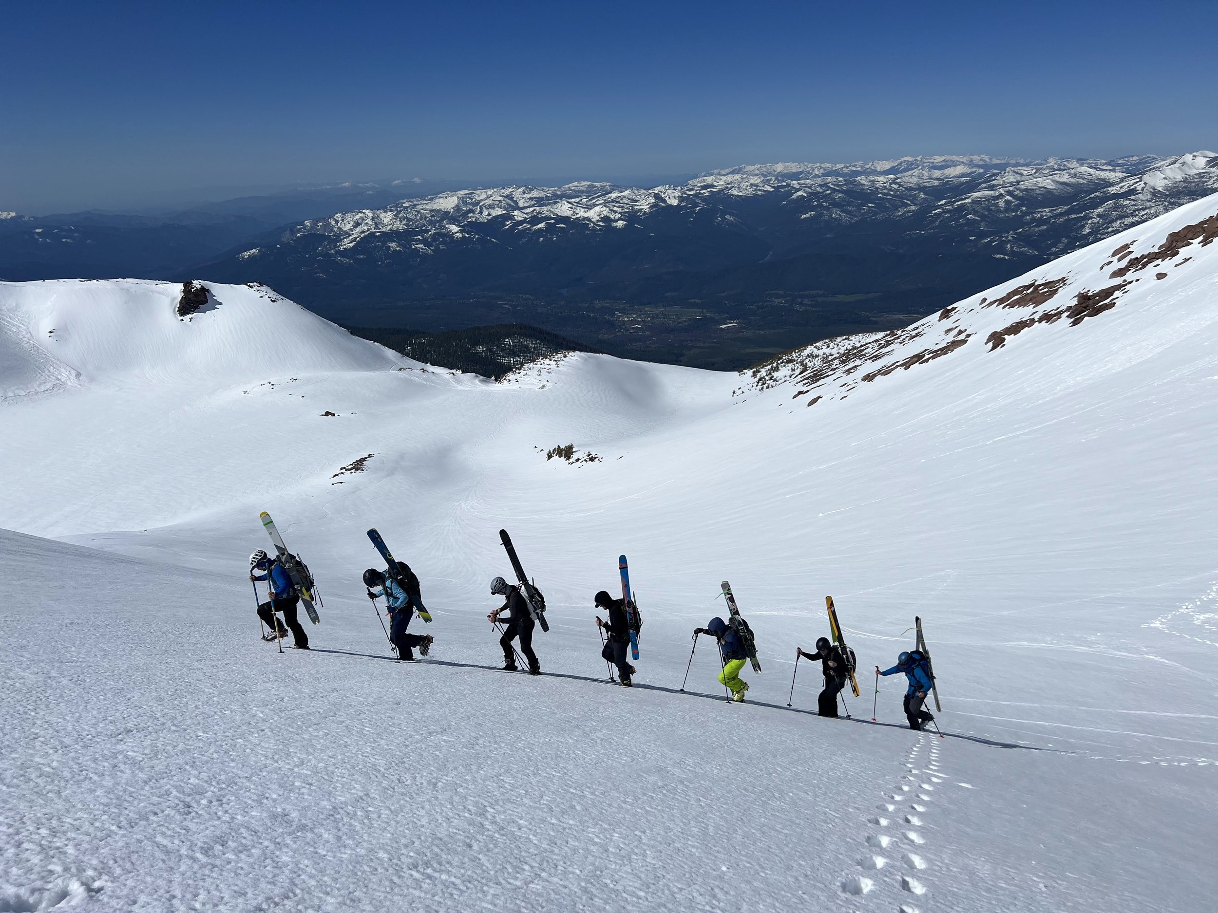 Group of skiers hikes up the slopes of mt shasta