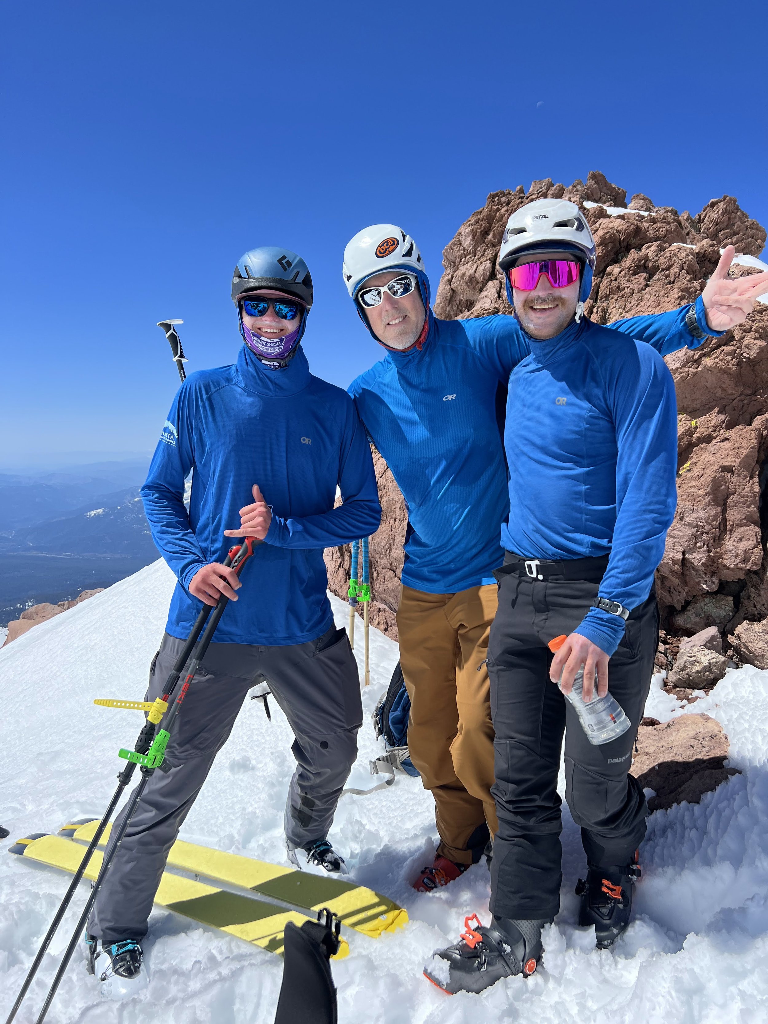 ski mountaineers pose at the summit of mt shasta