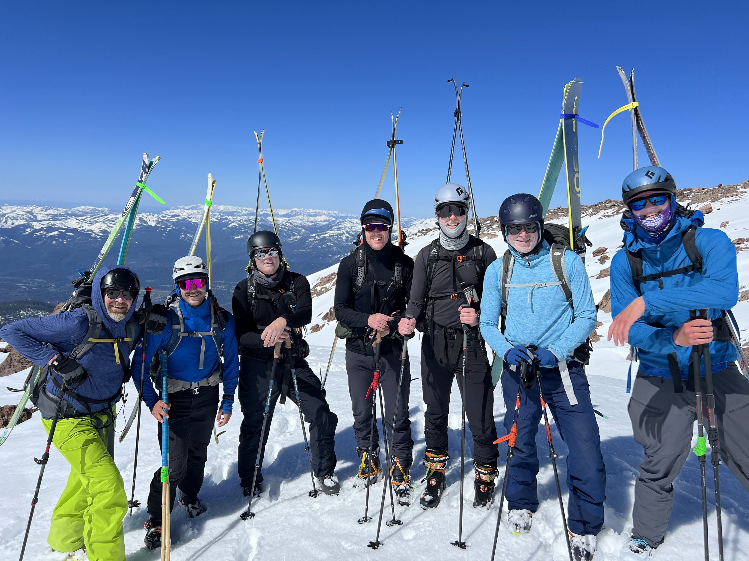 Group of skiers poses at the summit of mt shasta
