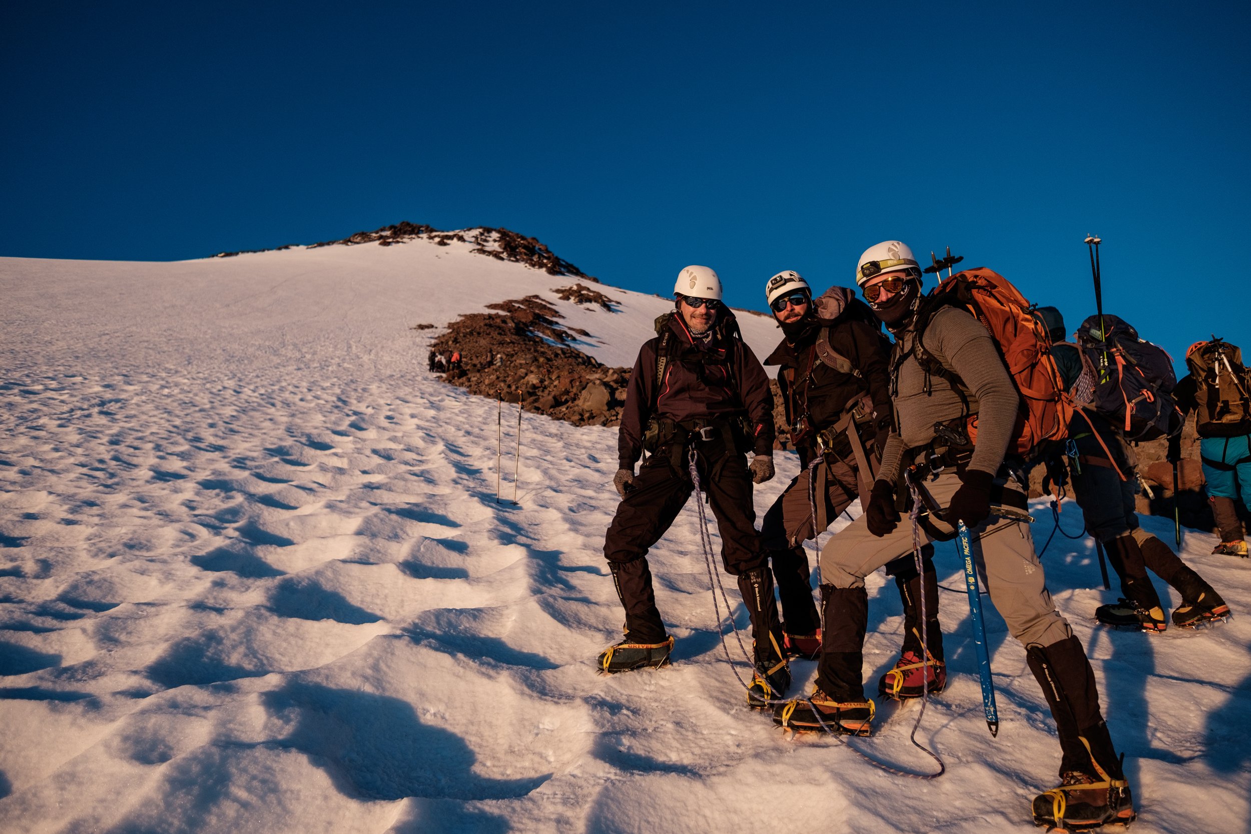 Mountaineers pose together on their summit attempt of mt shasta