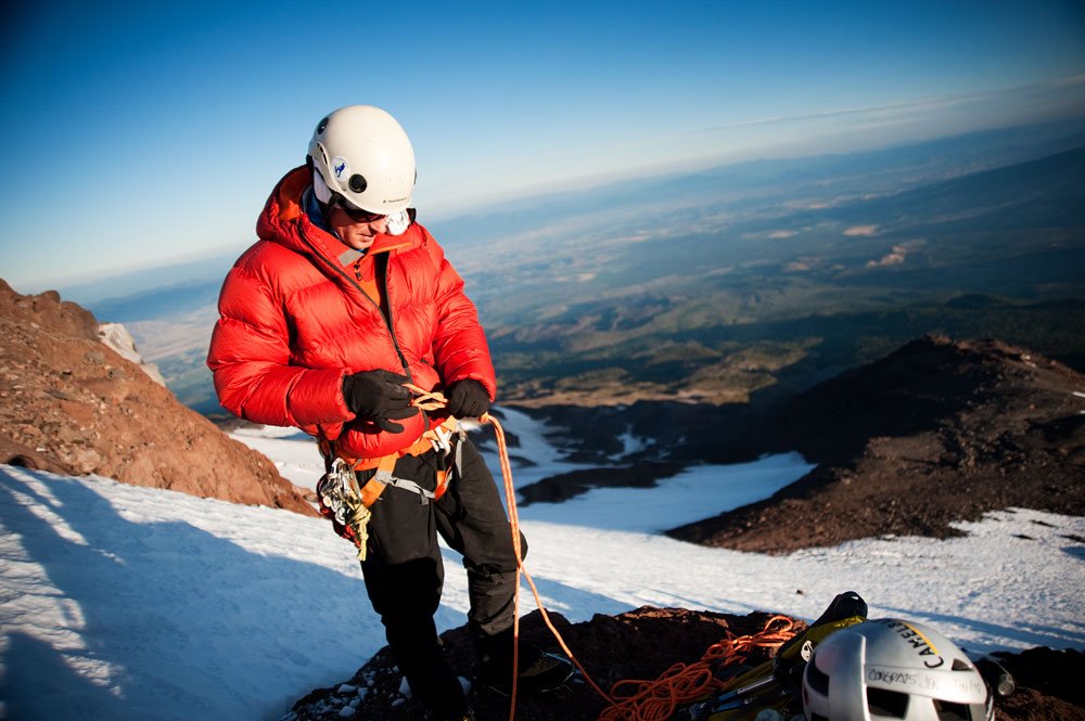 Mountaineer checks rope before short roping to the summit of Mt Shasta