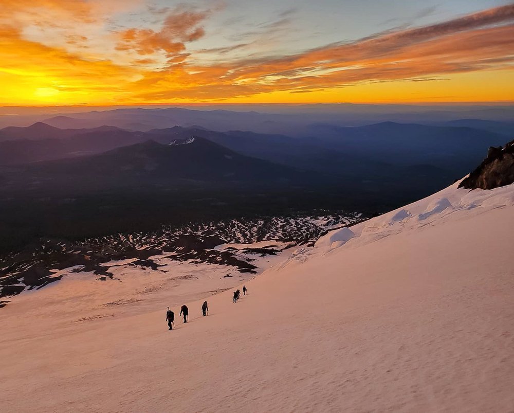 Mt Shasta mountaineers climb under the sunset