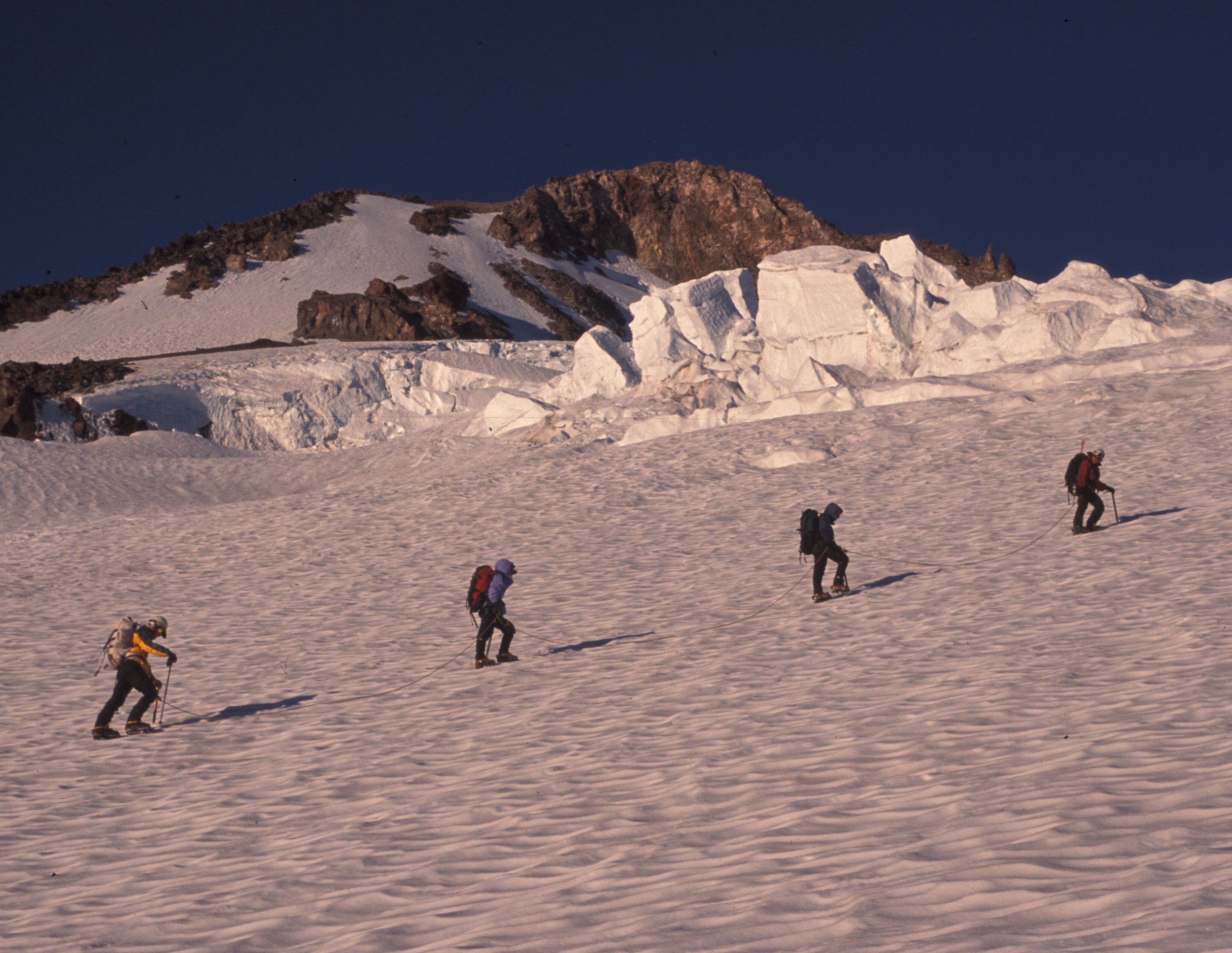 course participants assent to the top of mt shasta with glaciers in the back ground.