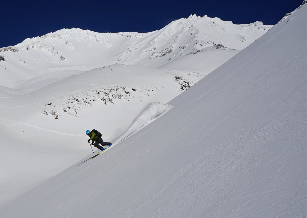 Skier rips down the snowy slopes of mt shasta