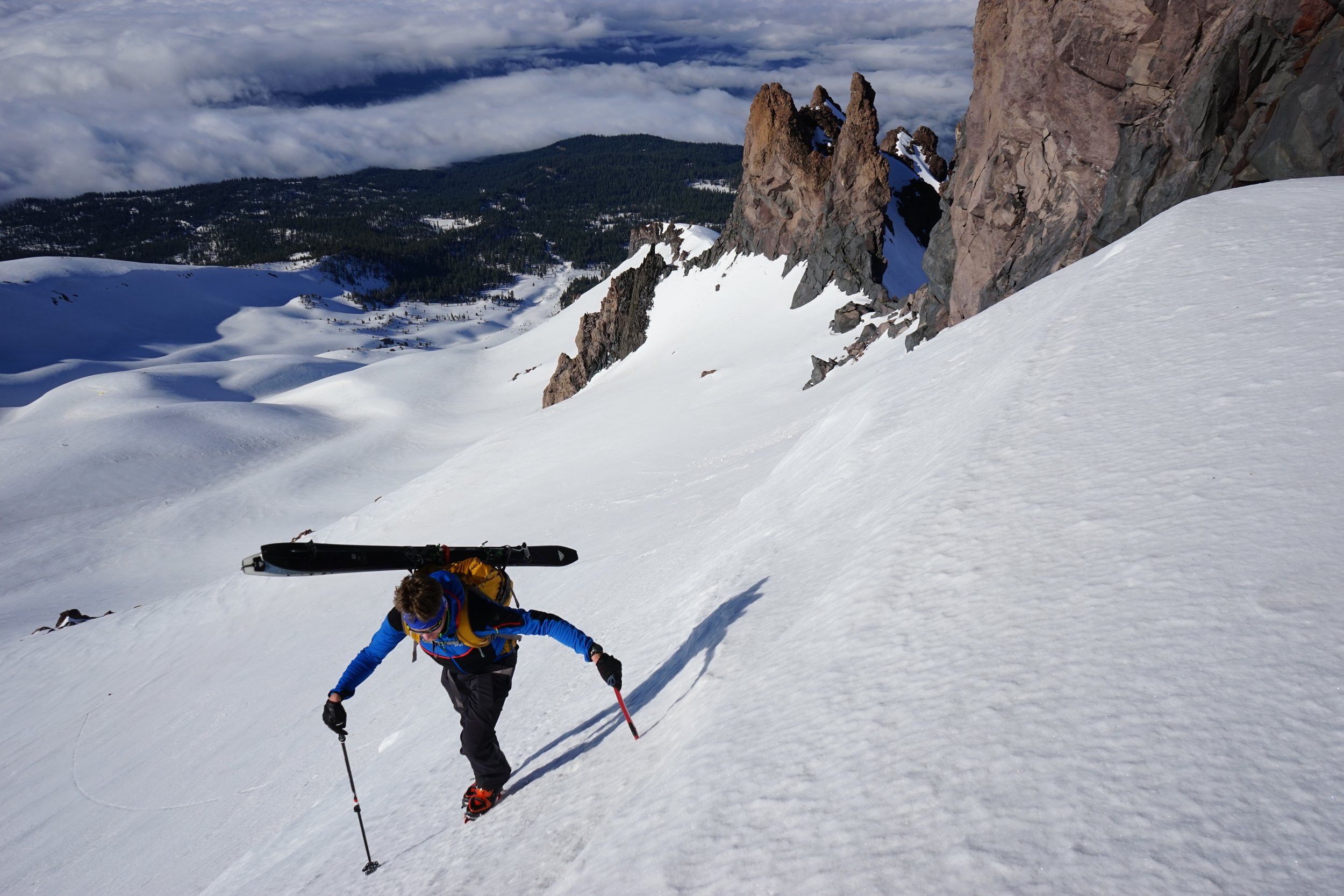 Ski mountaineer climbs toward the summit of mt shasta