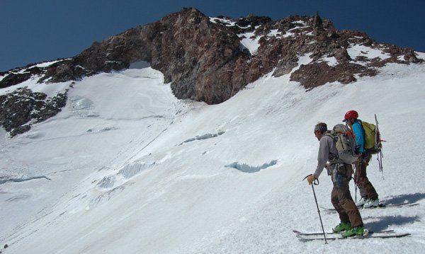 Advanced skiers navigate the crevasse on mt shastas glaciers