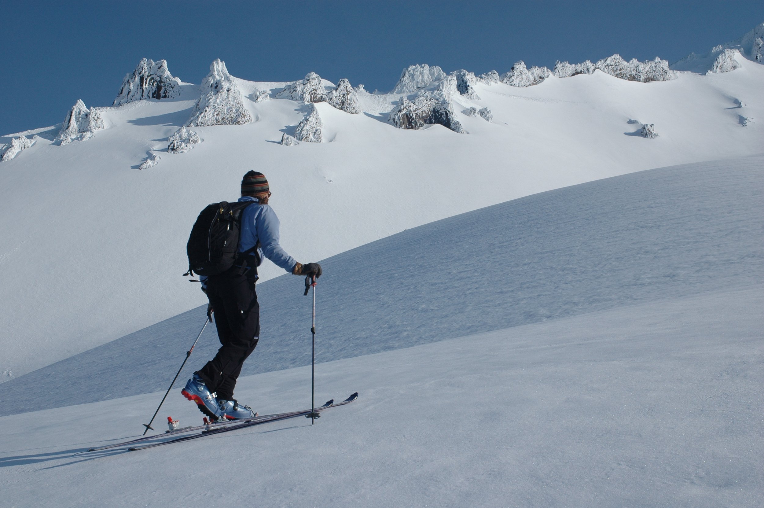 Female ski tours up the slope of mt shasta