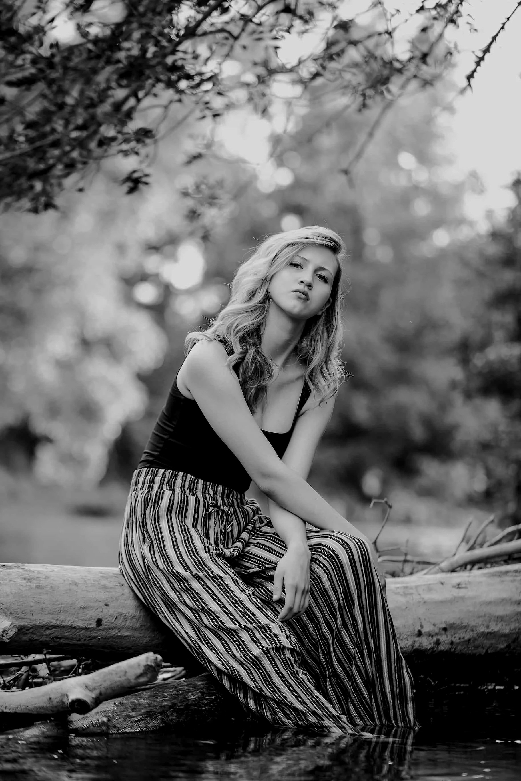 photo of a model with an emotional and dramatic pose at a river in calgary alberta