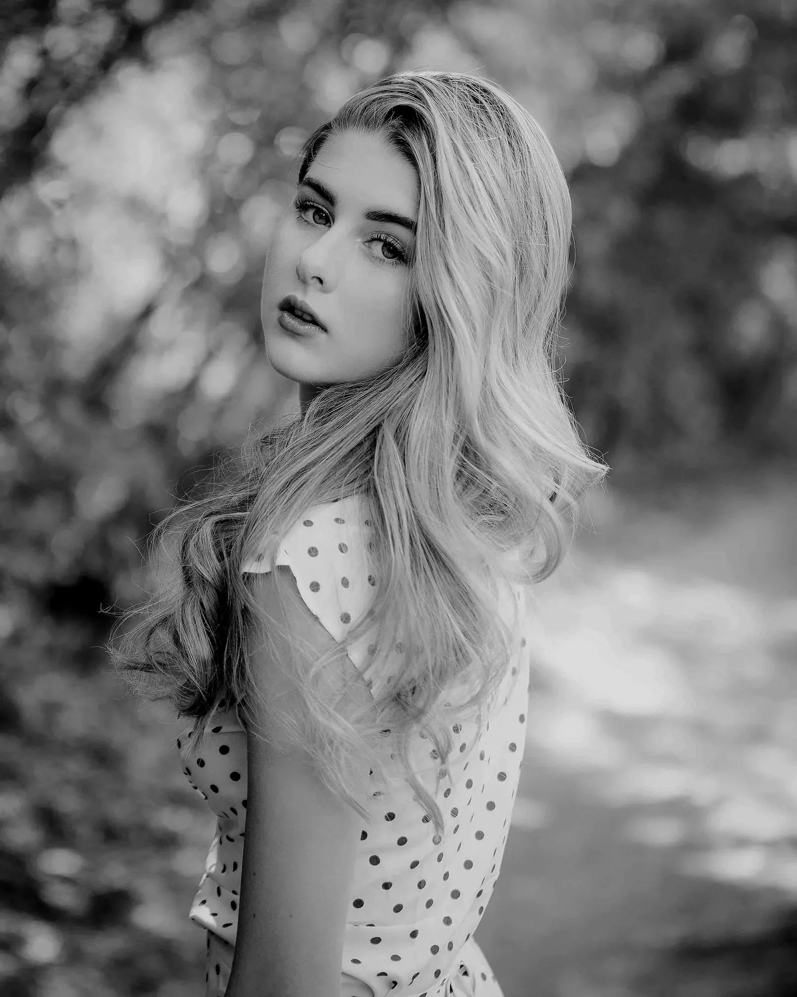 Model portrait photo of a girl posing near Roxboro & Erlton Offleash Dog Park in Calgary in the summer time