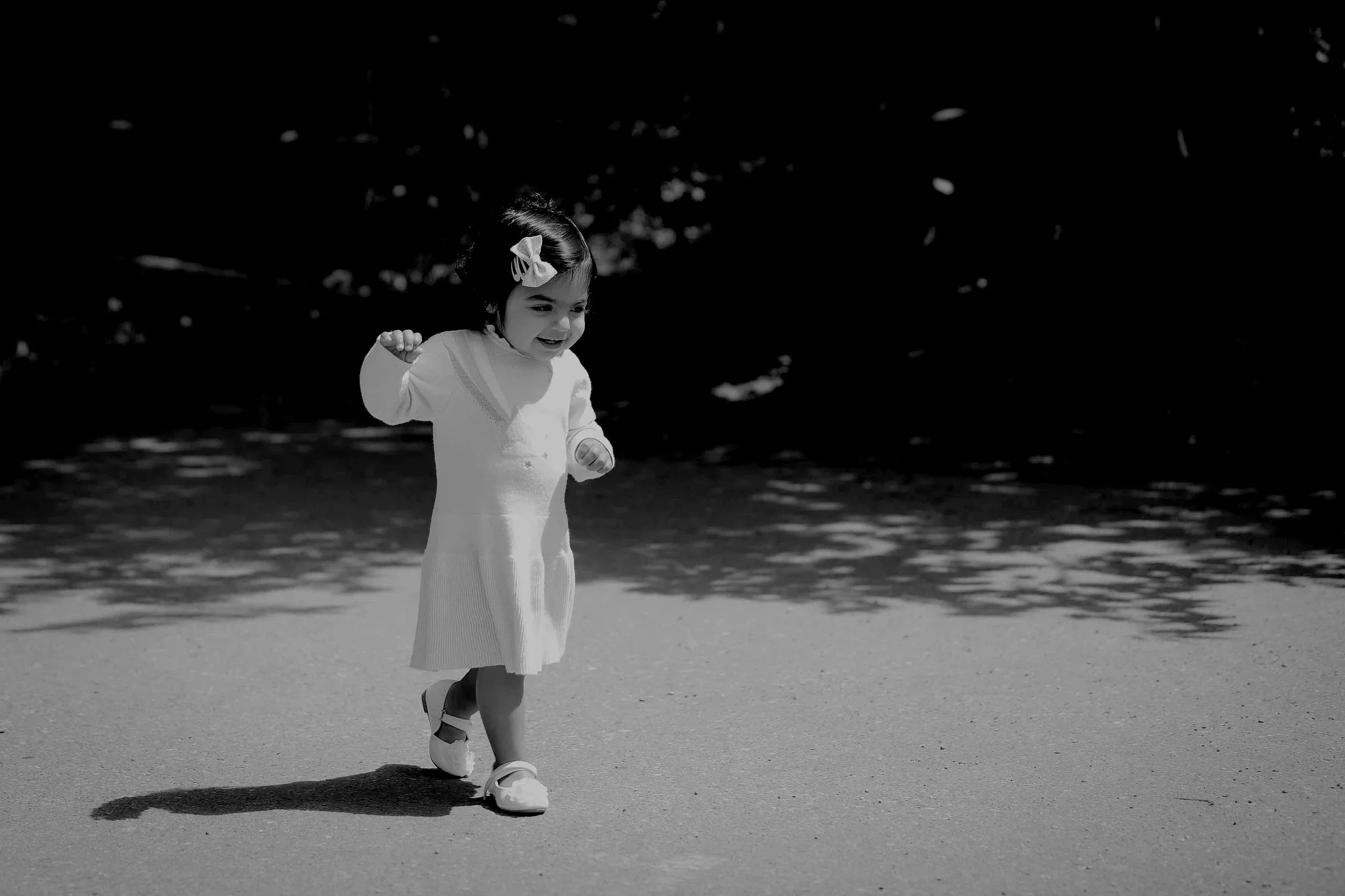 Portrait photo of a little baby girl running around at Lindsay Park in Calgary in the summer time
