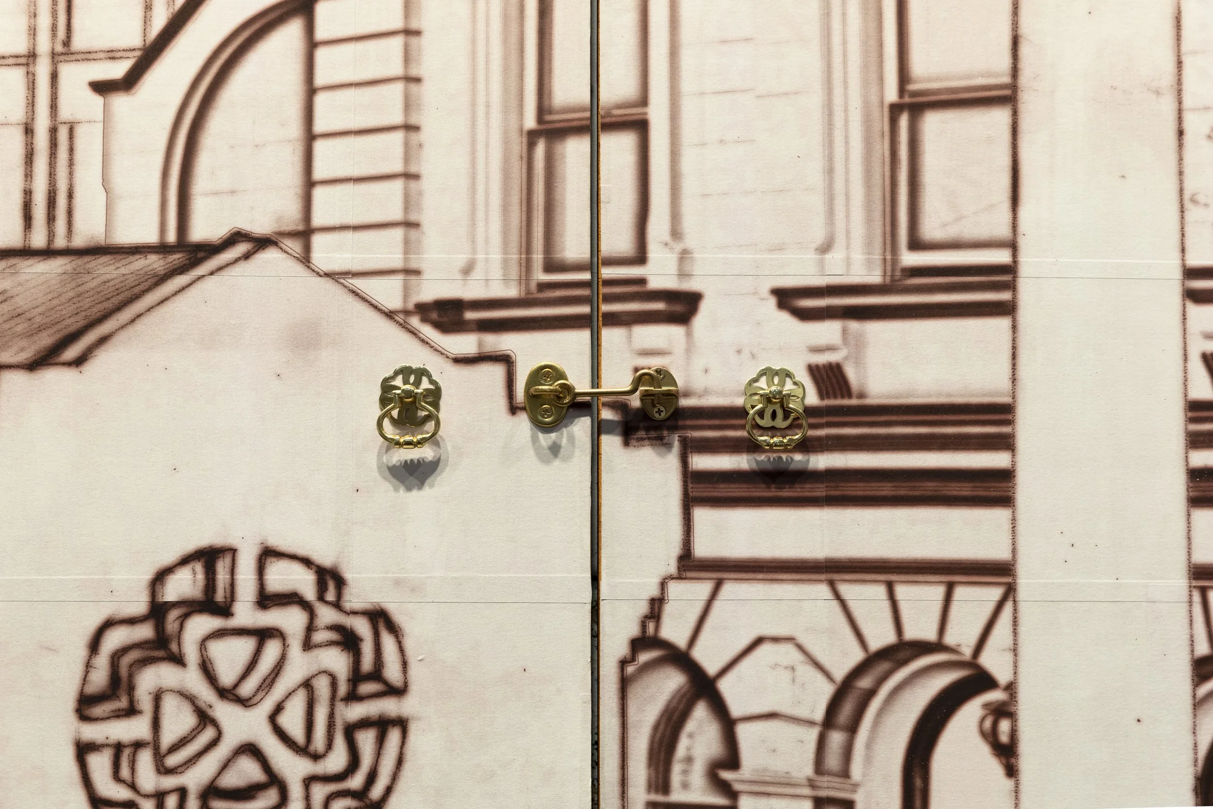 Detail of brass cabinet handle and latch hardware on doors. Photograph by Silversalt (Jennifer Leahy)