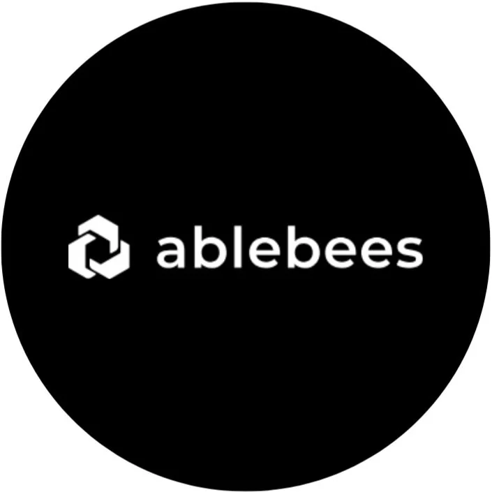 The Ablebees logo on a black circular background, featuring a geometric bee icon and the word 'ablebees'.
