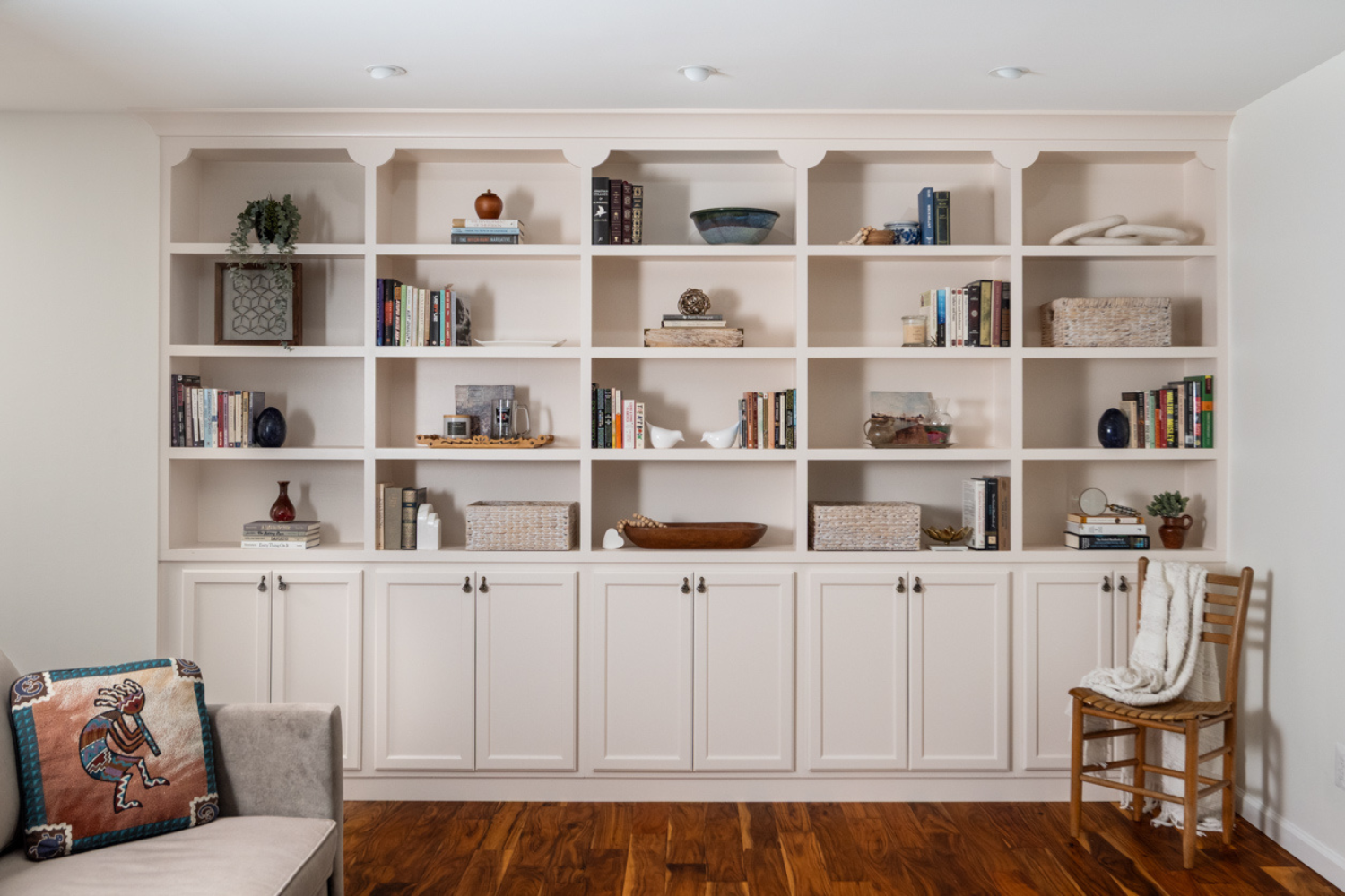 Custom built-in living room cabinetry with open shelving and enclosed storage, providing a beautiful, functional solution that maximizes organization and complements the home's architecture.